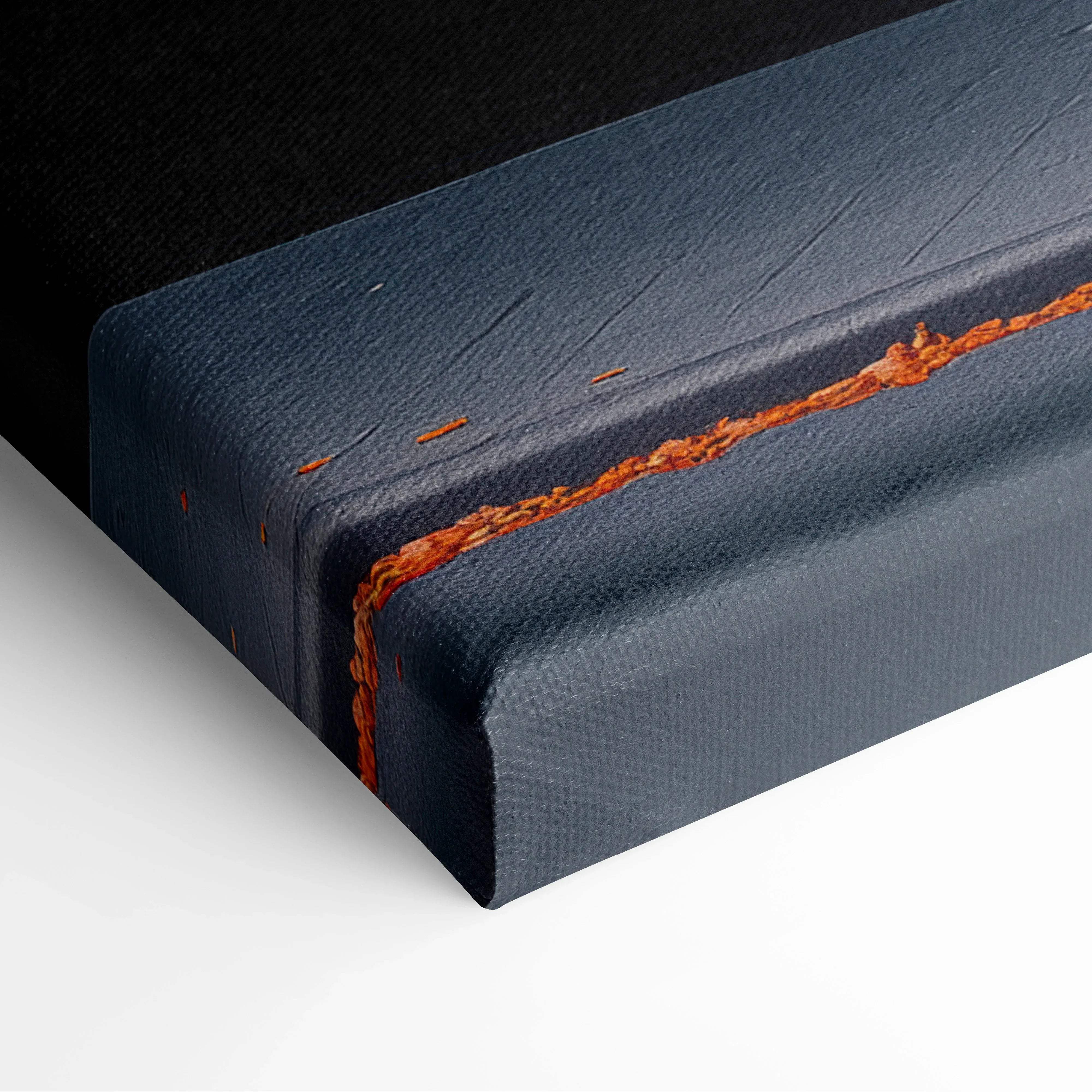 Dark blue canvas wall art with textured surface and contrasting orange stitching for modern home decor