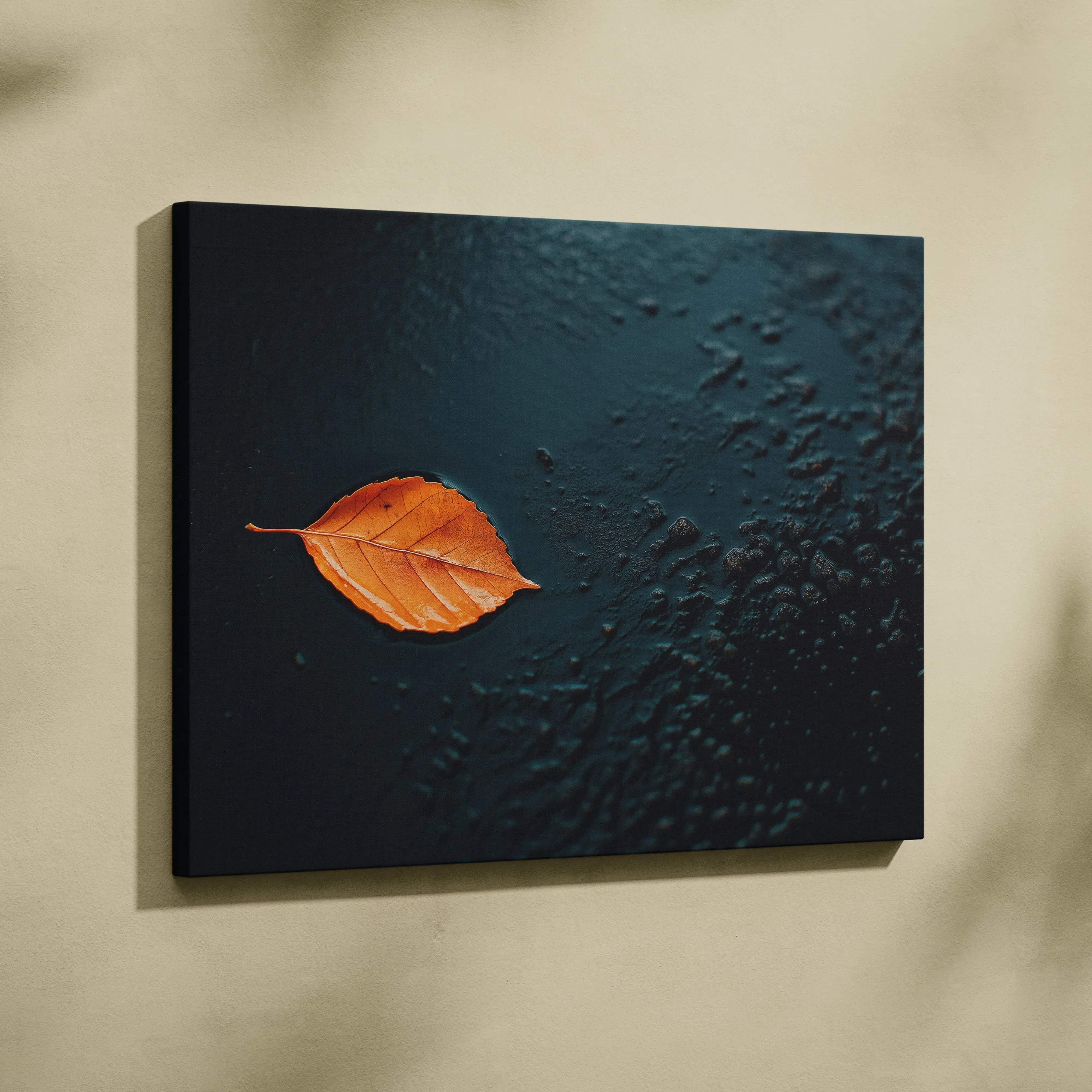 Minimalist autumn leaf canvas wall art with a vibrant orange leaf on dark textured fabric for modern decor