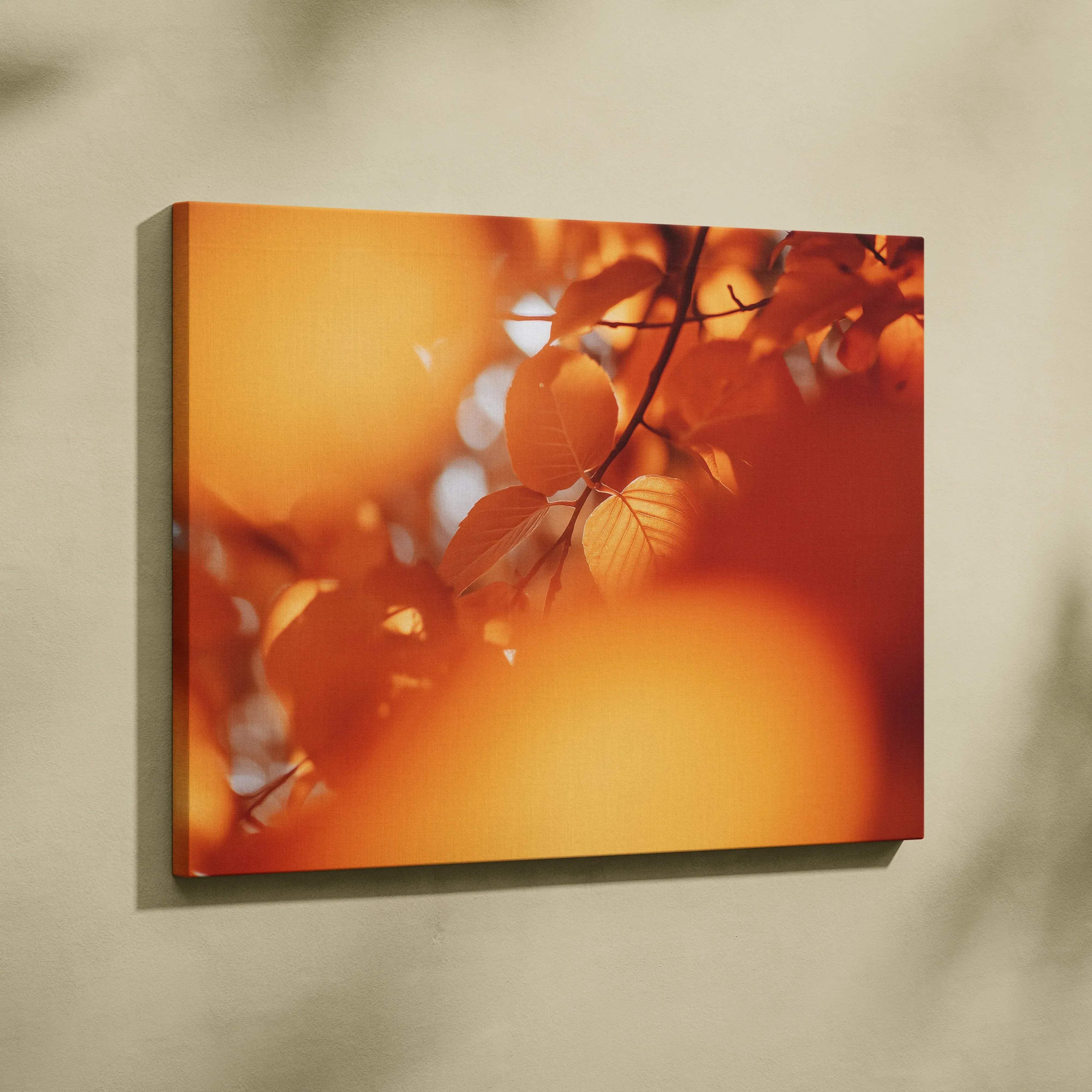 A rectangular canvas print of warm orange autumn leaves with soft sunlight in a minimalist cozy nature scene
