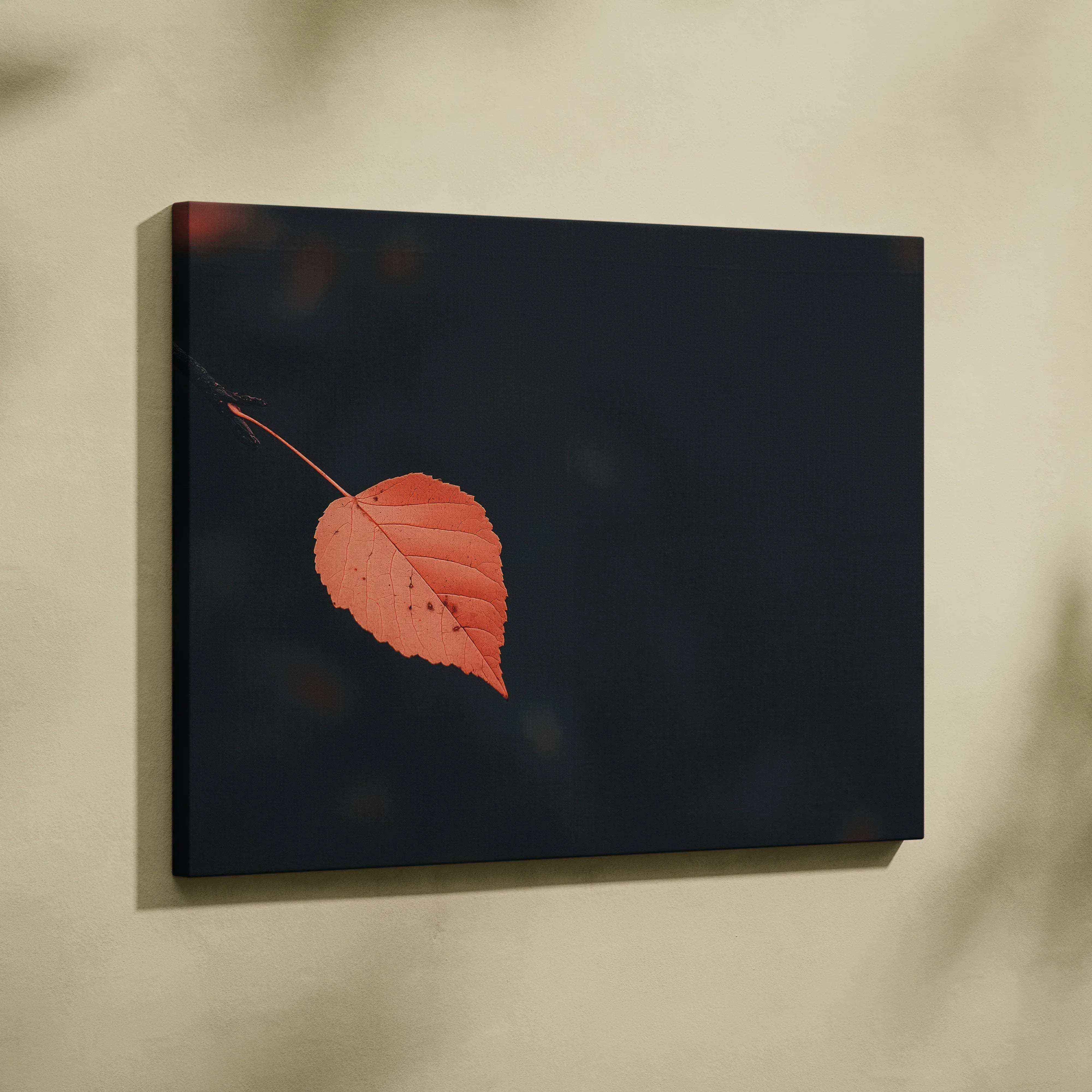 Minimalist autumn leaf canvas wall art featuring a single vibrant orange leaf on a deep black background for serene decor