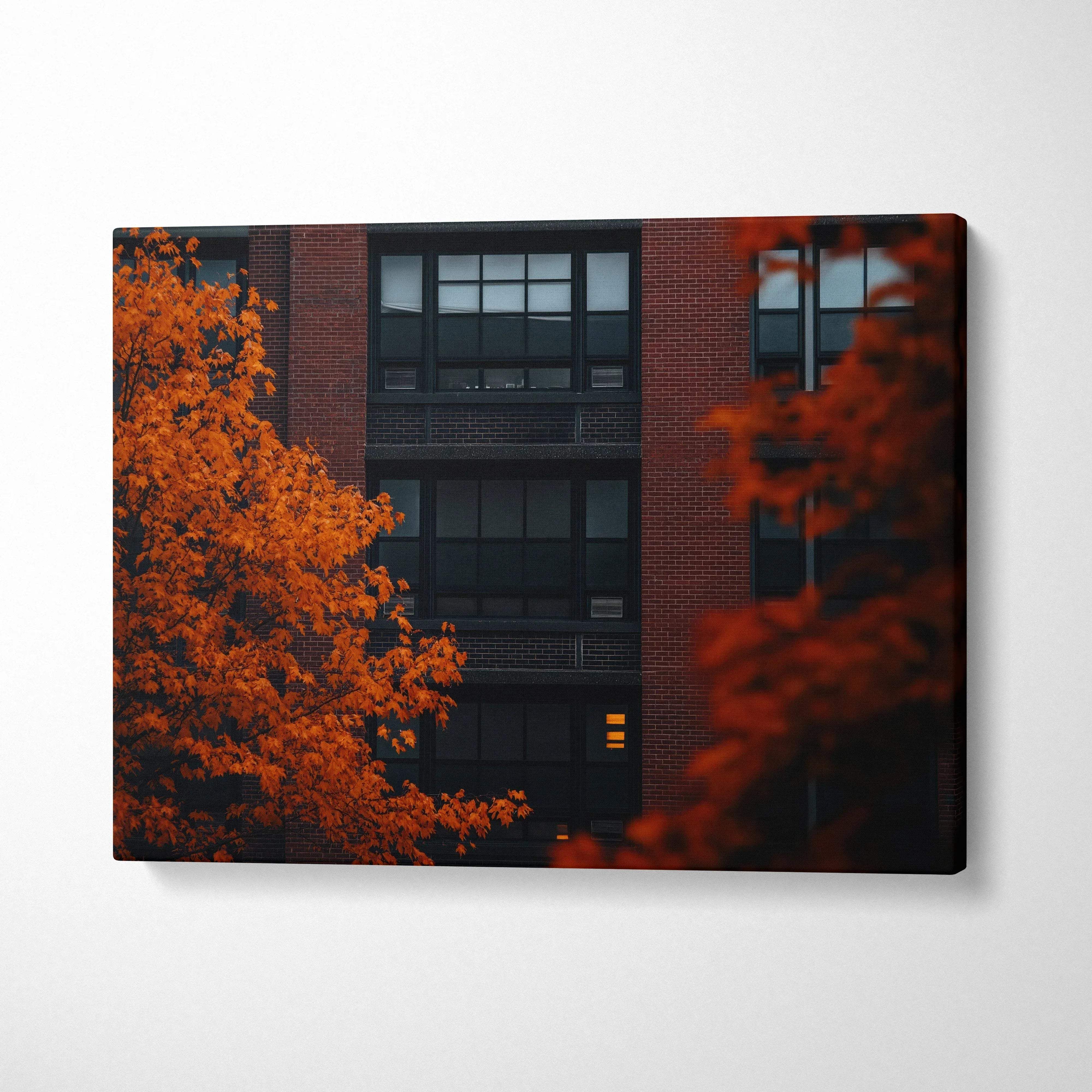 Canvas wall art featuring vibrant autumn leaves against a dark urban building backdrop.