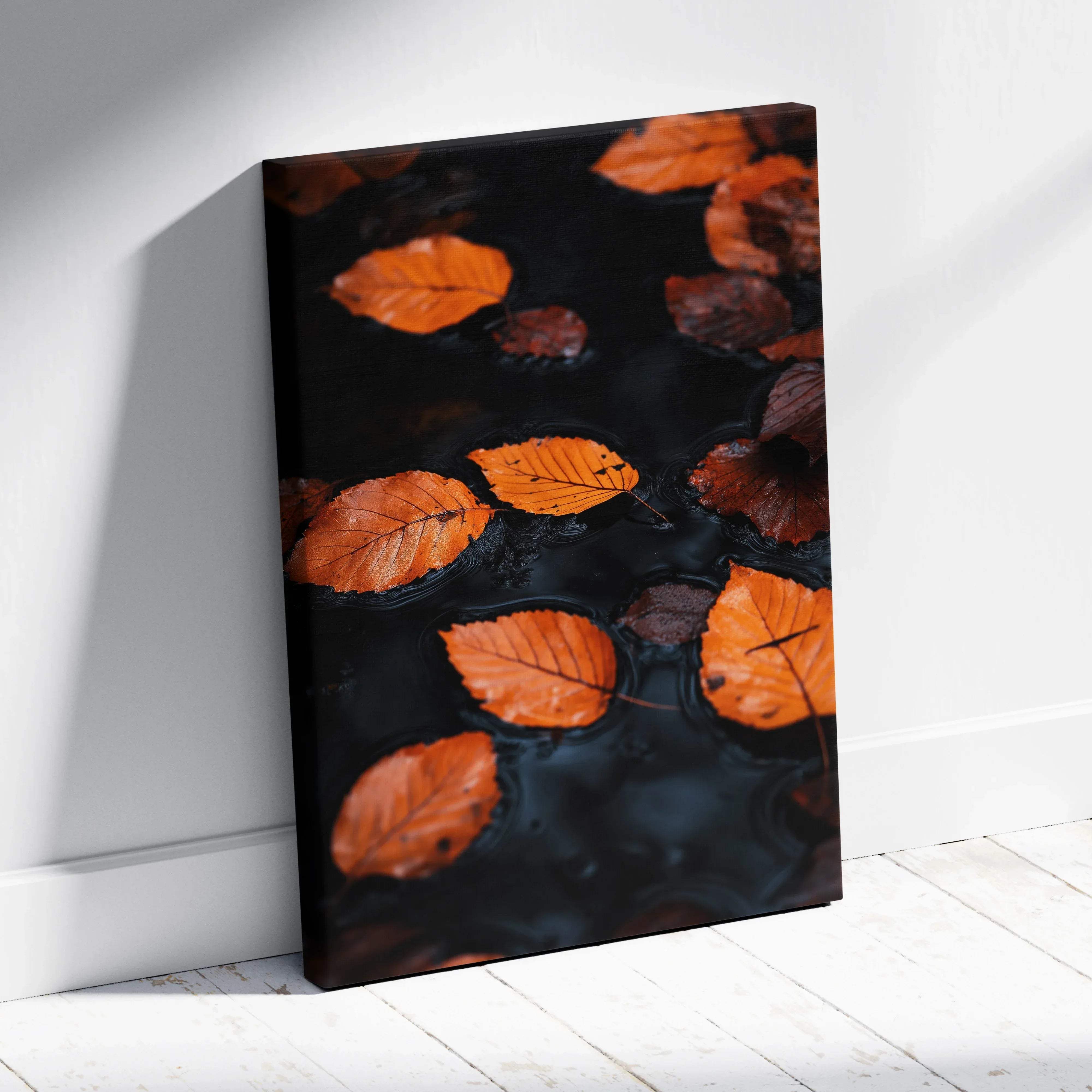A rectangular canvas print of vibrant orange and brown autumn leaves floating on dark water wall art