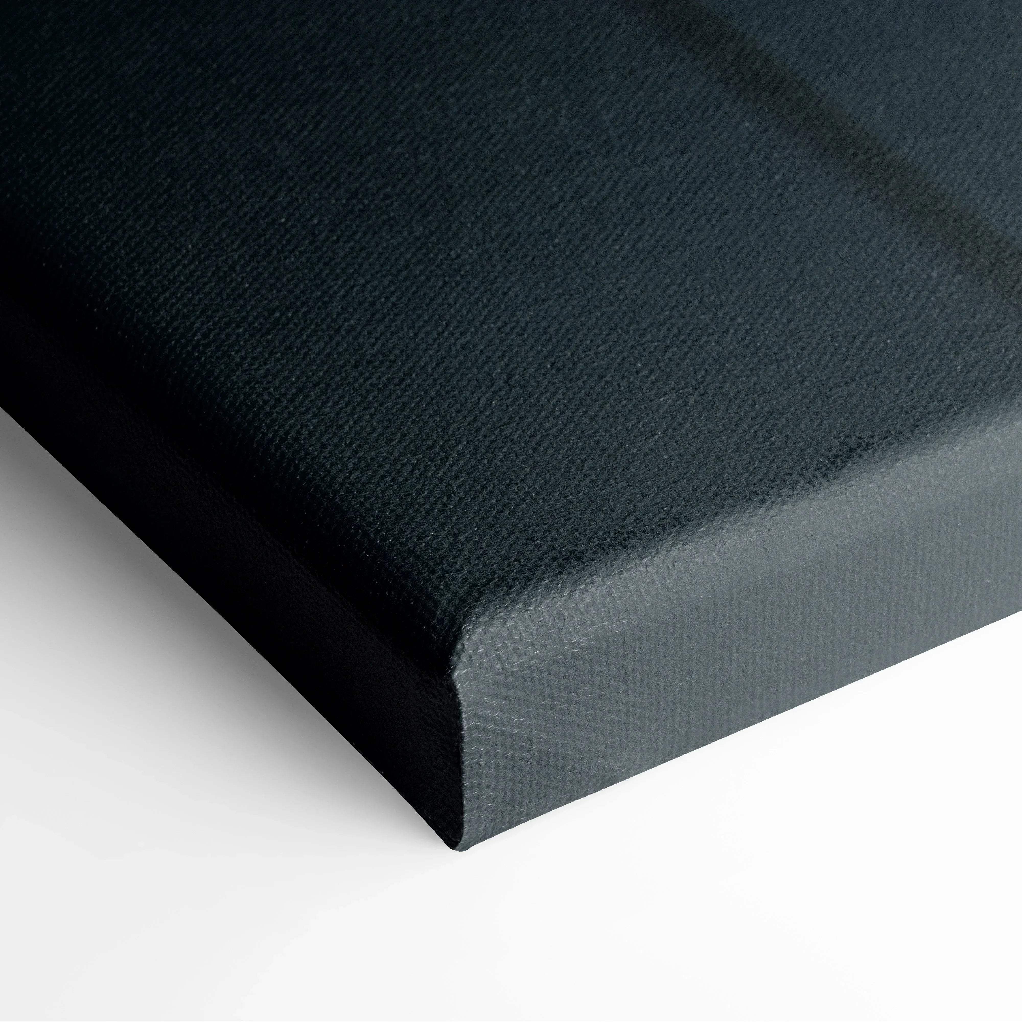 Black canvas print with textured surface and raised edges featuring warm orange autumn leaves on moody blue backdrop