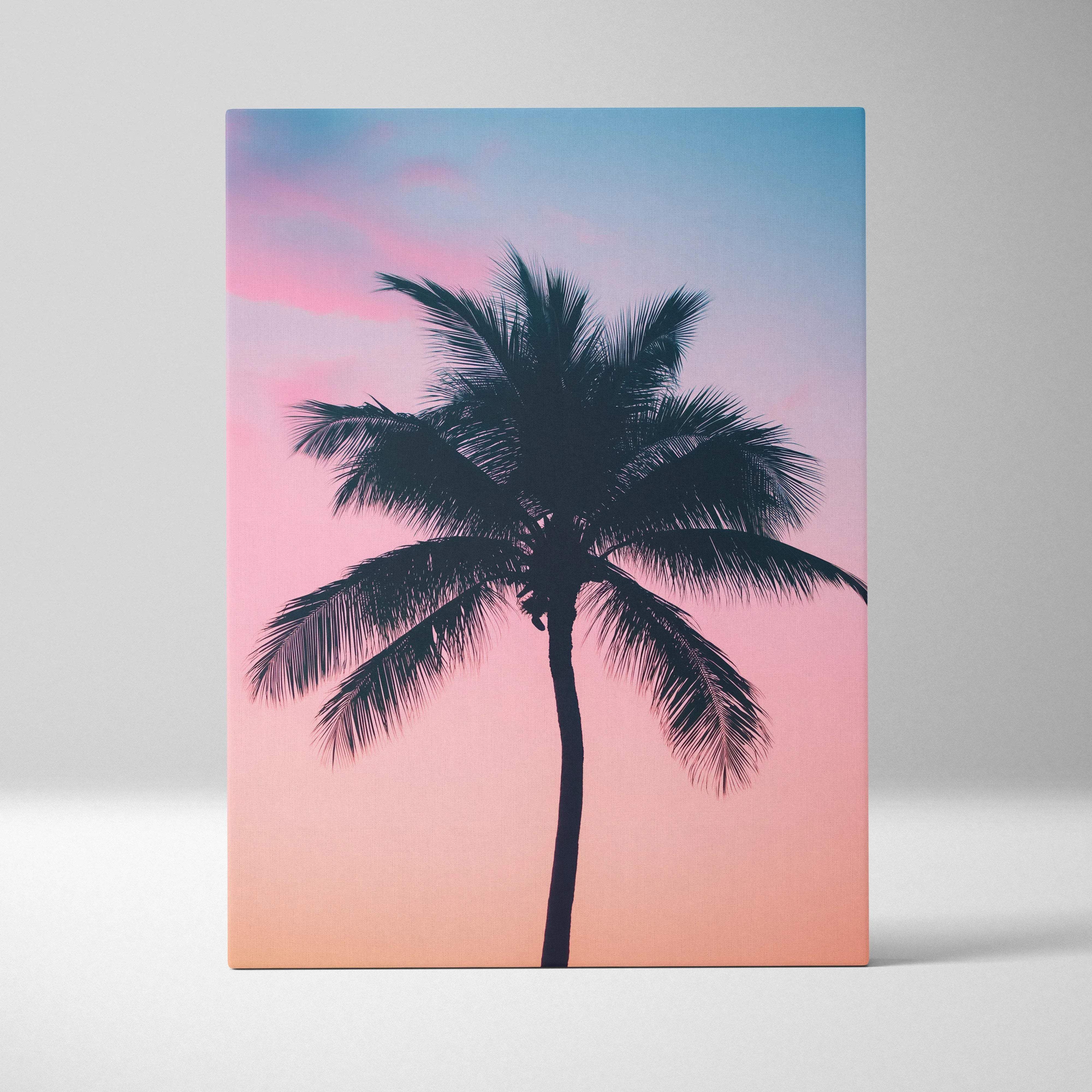 A rectangular canvas print featuring a black palm tree silhouette against a pink to blue gradient sky for tropical decor