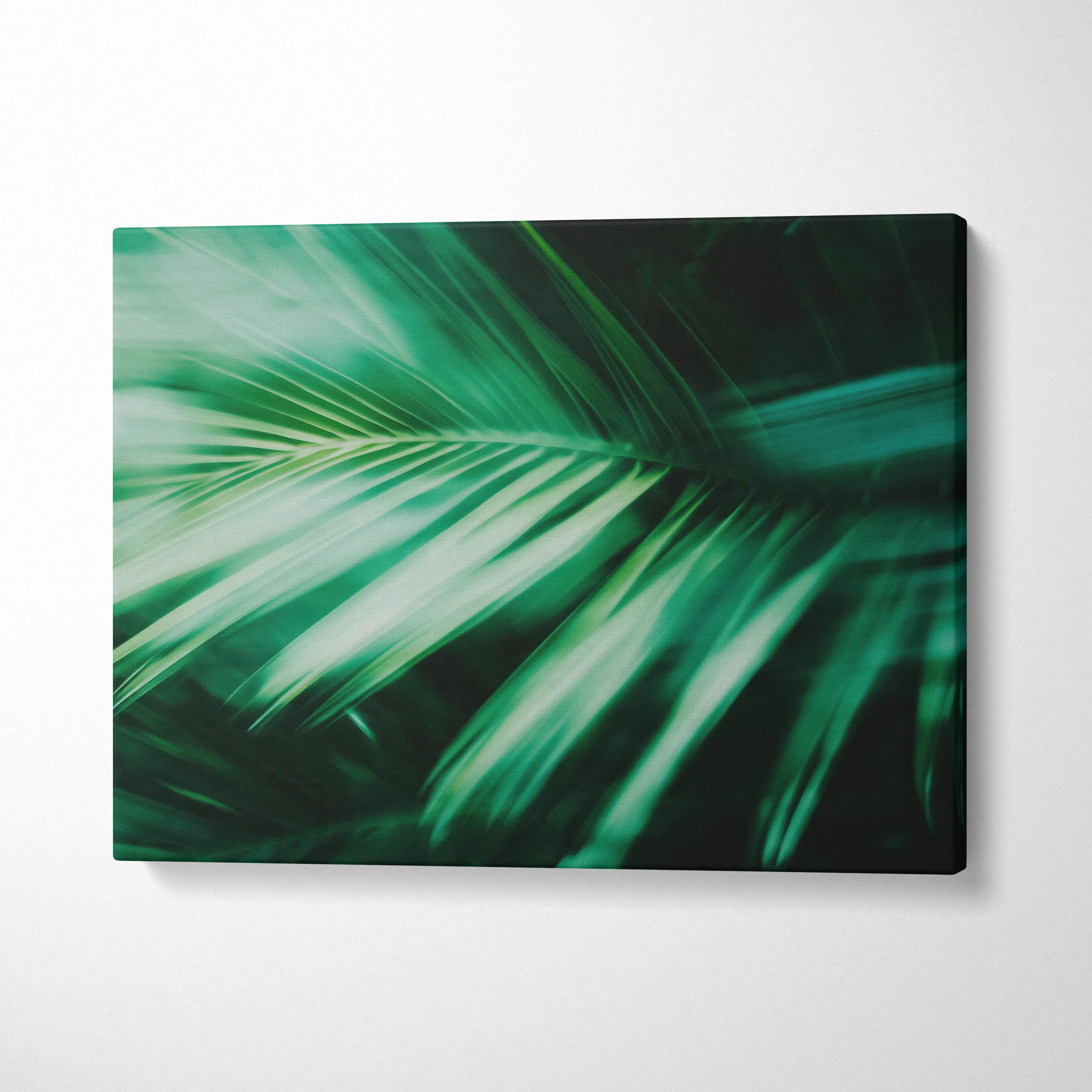 Tropical green palm leaves close-up on canvas wall art with motion blur decor.