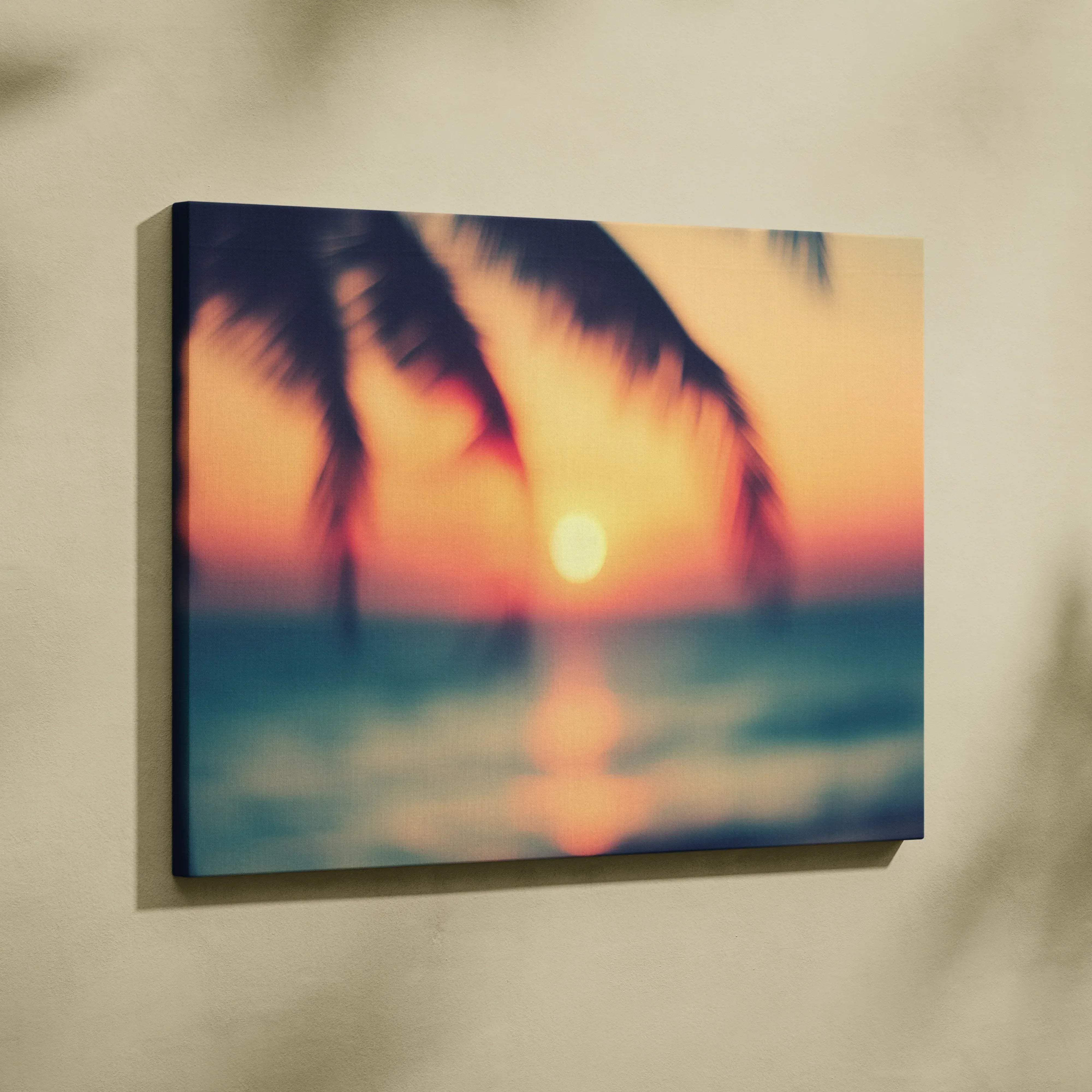 A square canvas print of a dreamy tropical sunset with blurred orange and pink hues over ocean and palm tree silhouettes