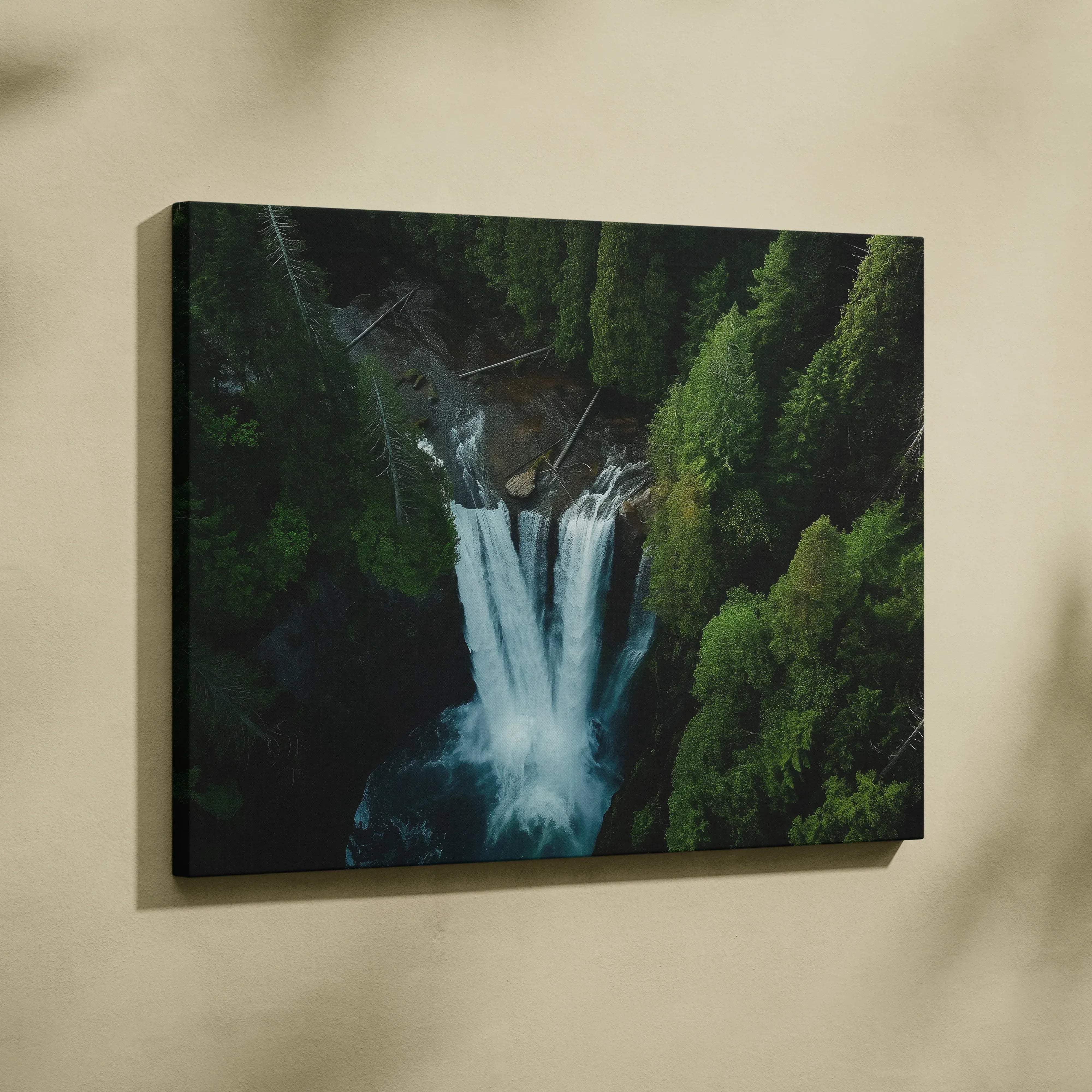 A framed canvas print of a vibrant aerial view waterfall surrounded by lush green forest for wall art decor