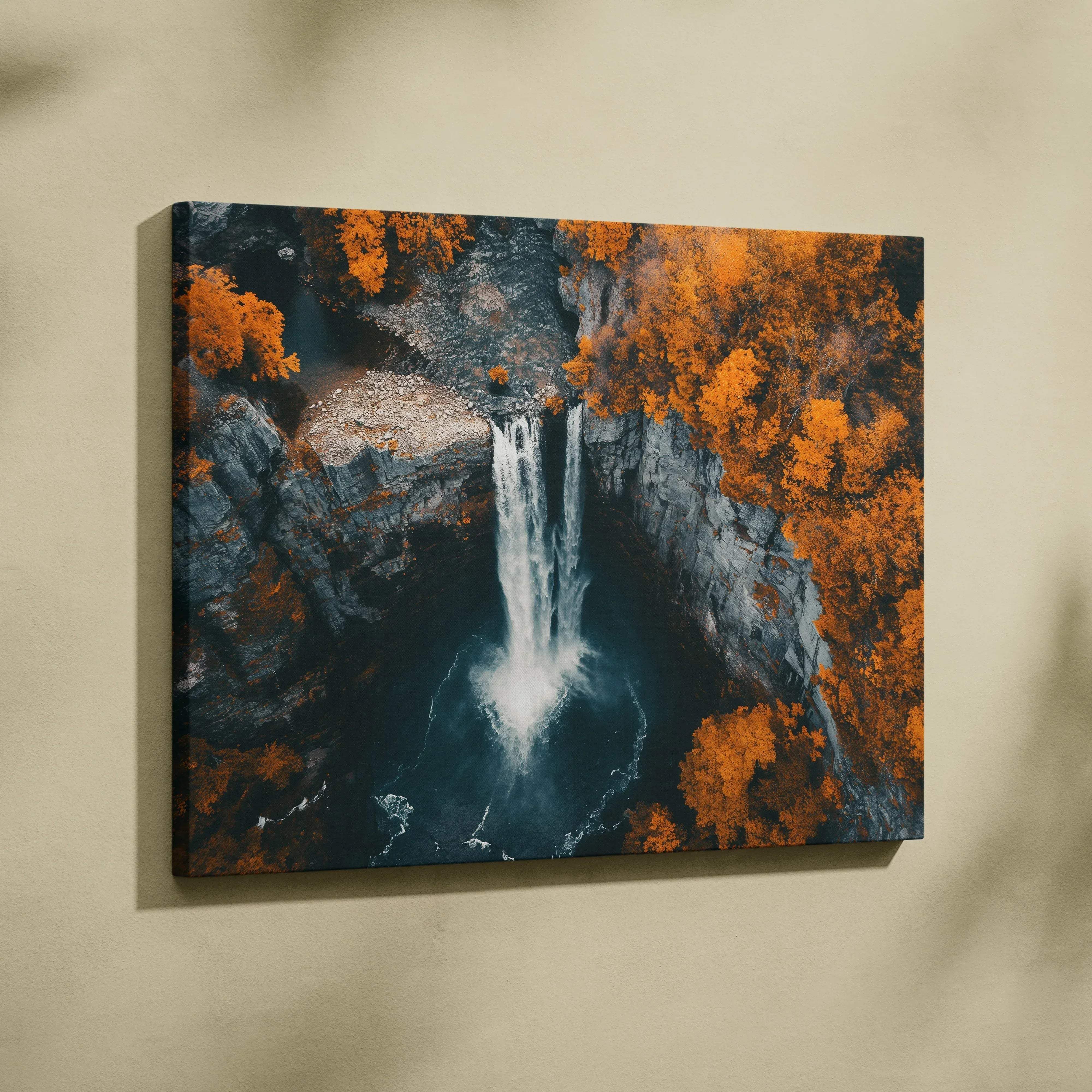 A rectangular canvas print featuring a vibrant autumn waterfall scene with orange foliage and dark rocky cliffs