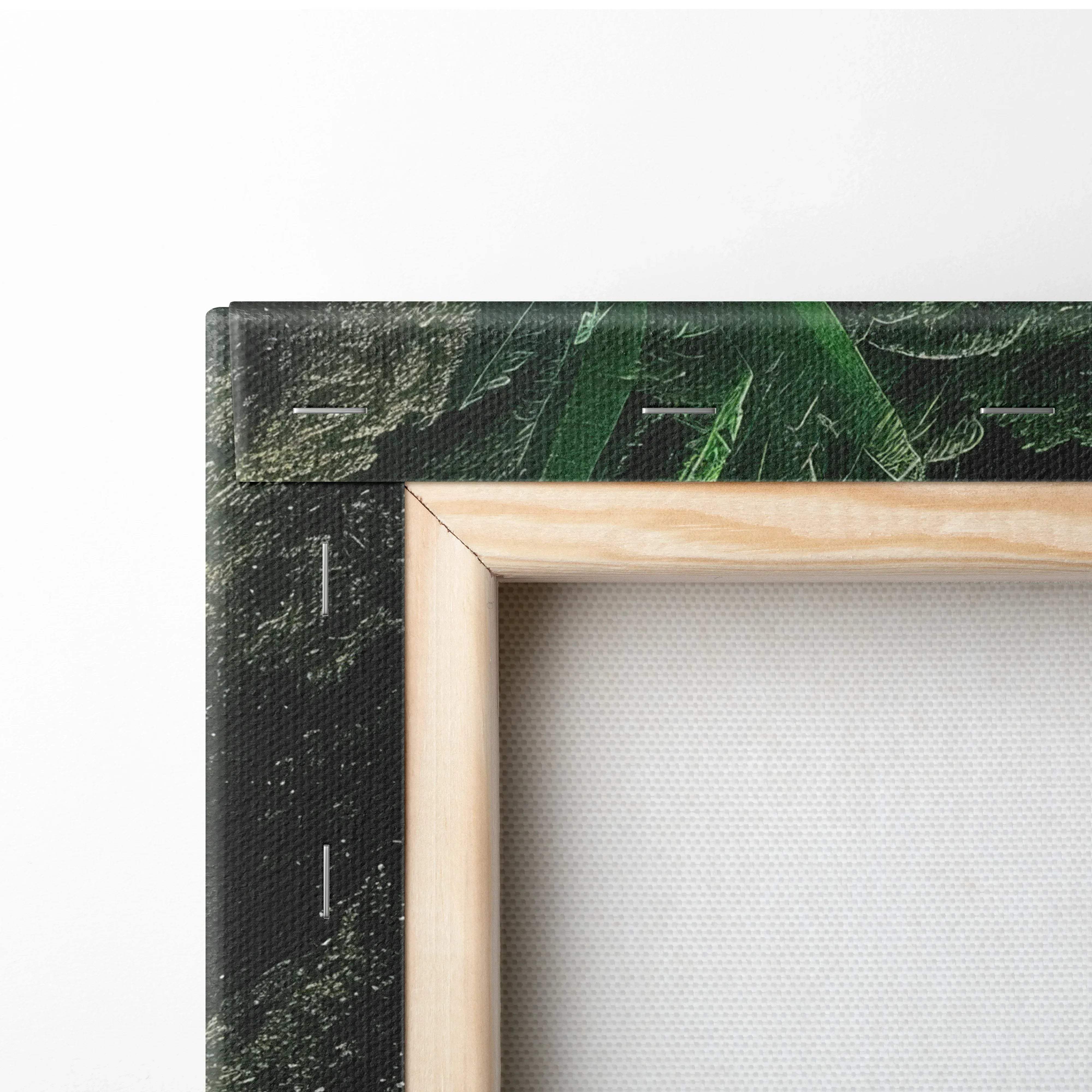 Light-colored wooden frame holding a high resolution canvas print with dark green foliage for wall art decor