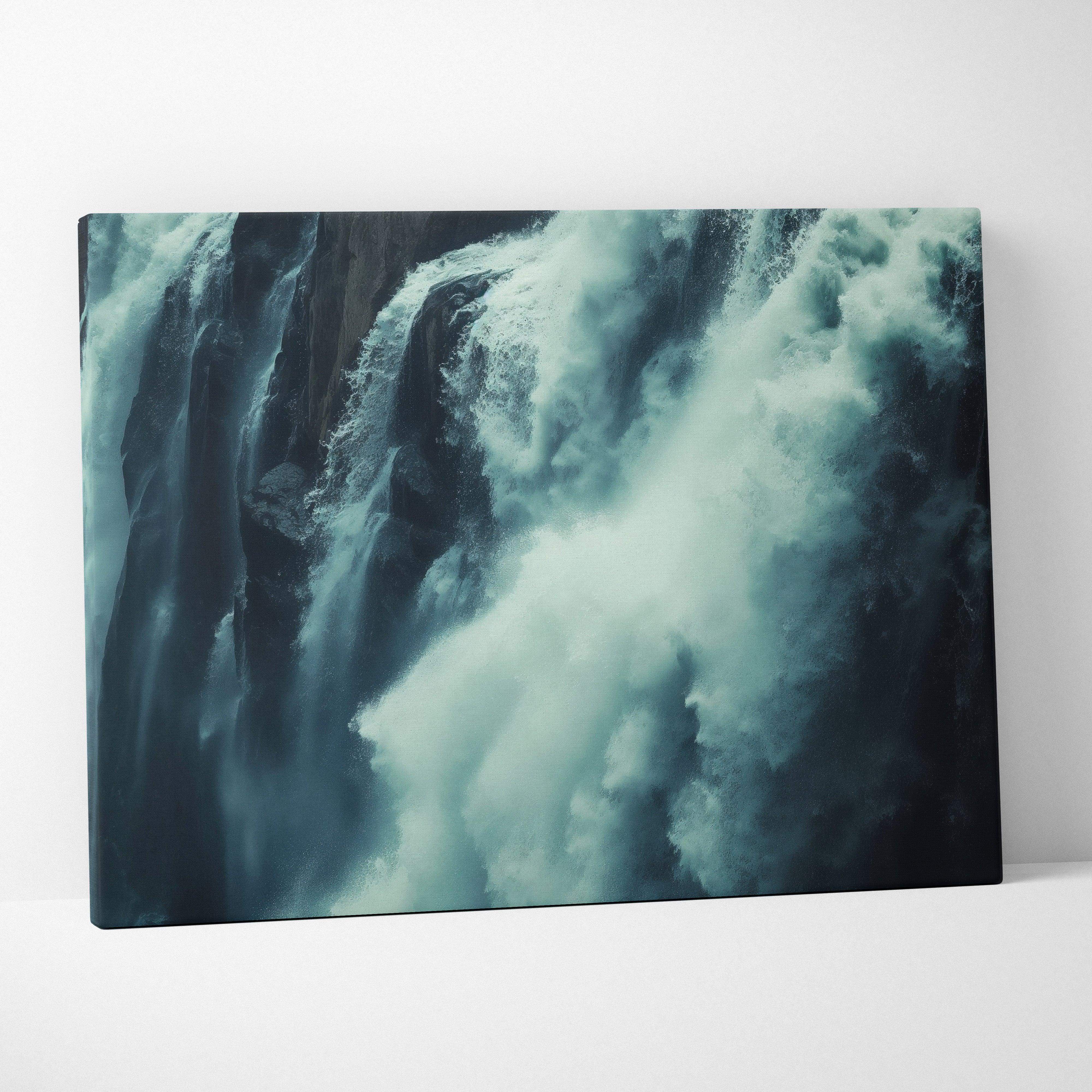 A canvas print showing a dramatic waterfall with swirling white and teal water over dark rocky cliffs for nature decor