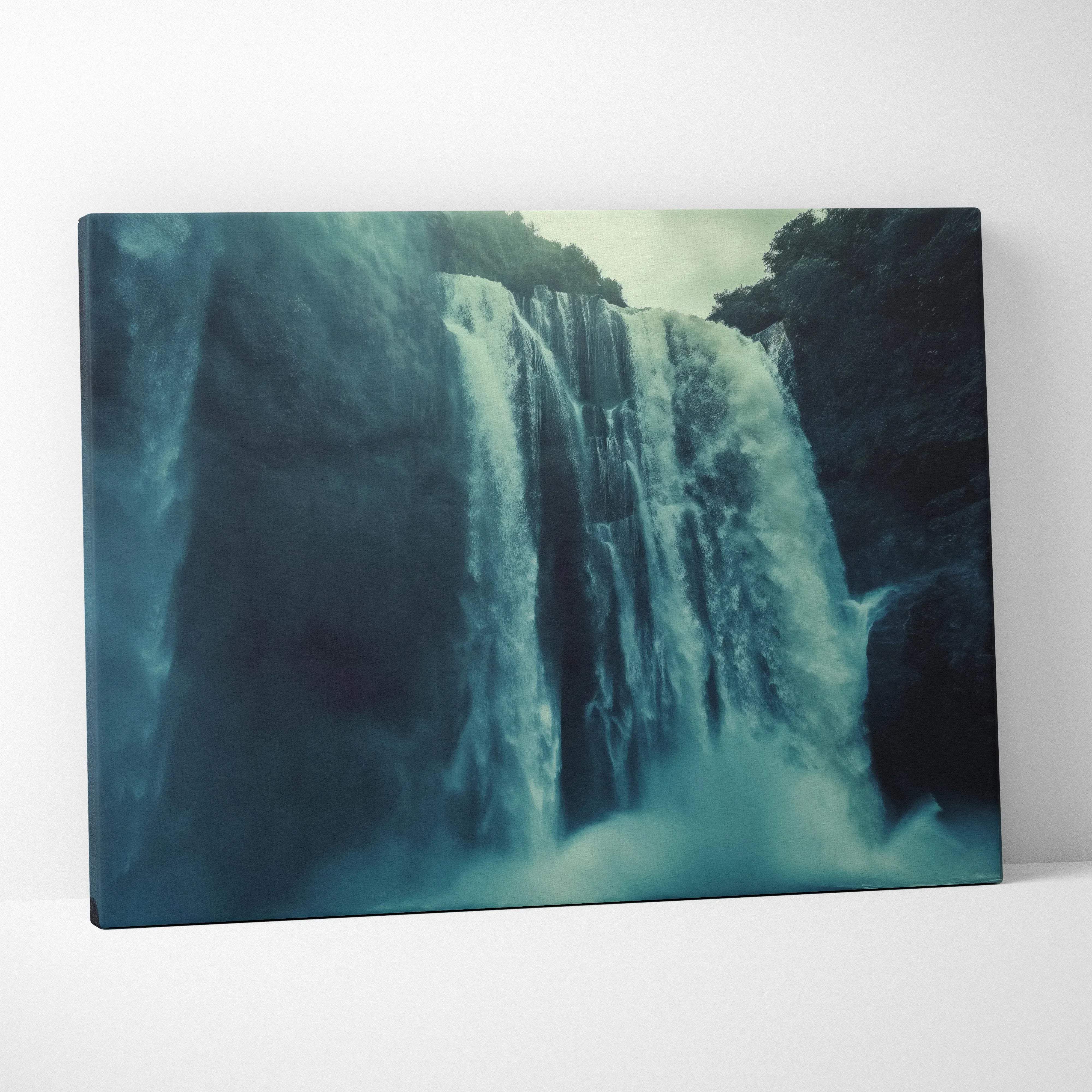 Rectangular canvas wall art of a waterfall in teal and dark blue framed by rocky cliffs for modern home decor