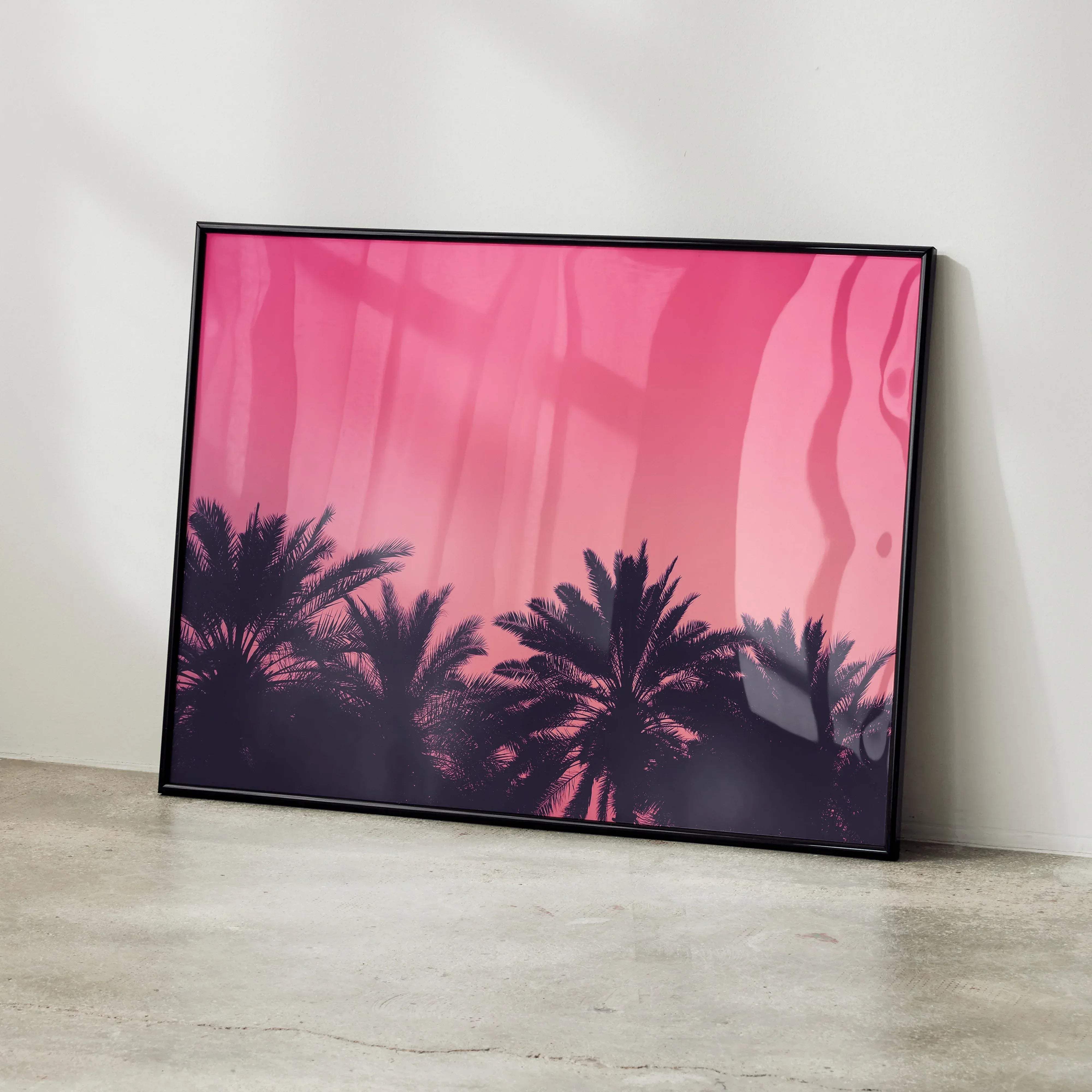 A serene beach digital art poster featuring silhouetted palm trees against a pink gradient sky in a black frame