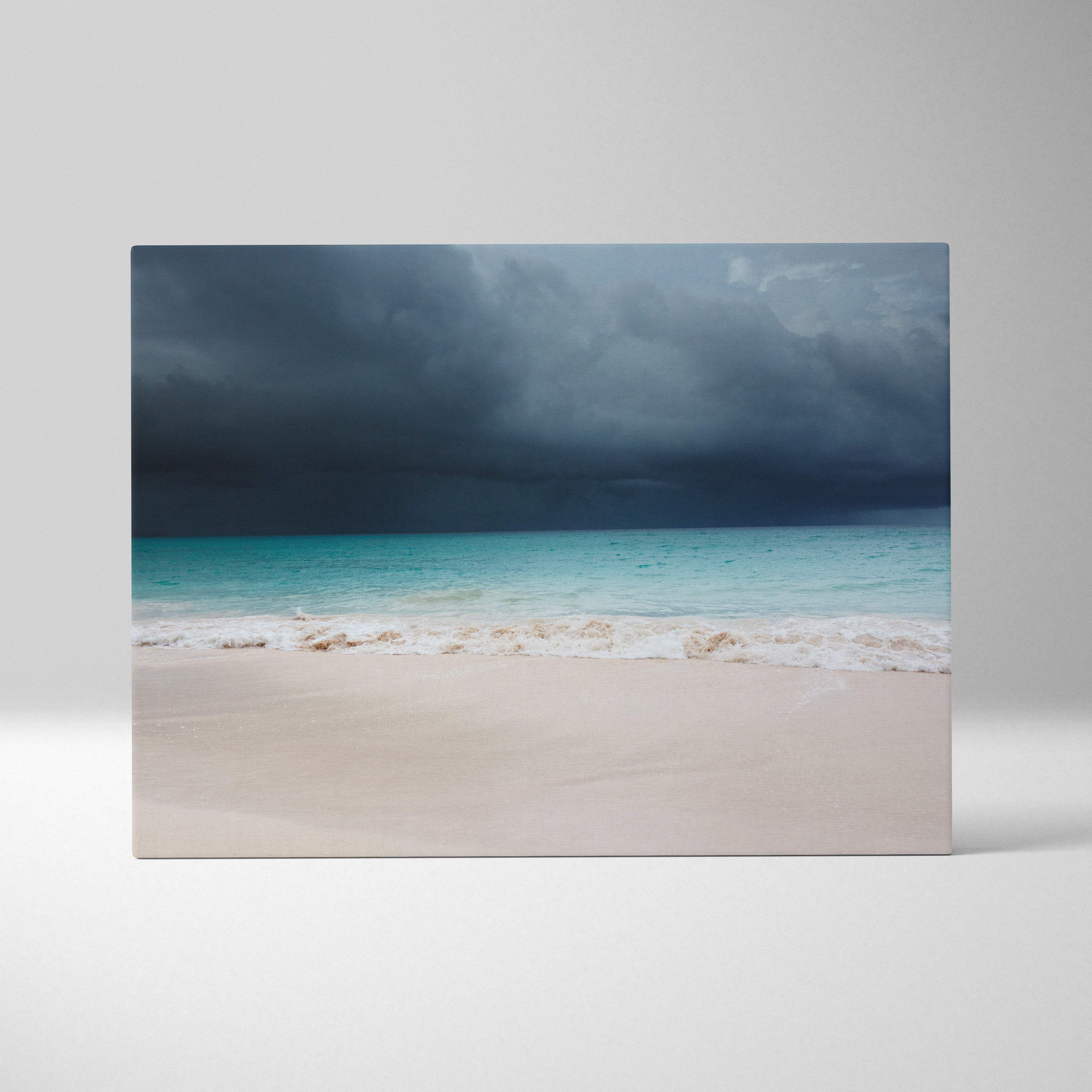 Stormy beach canvas art featuring turquoise waves white sand and dark thunderclouds moody coastal landscape wall decor