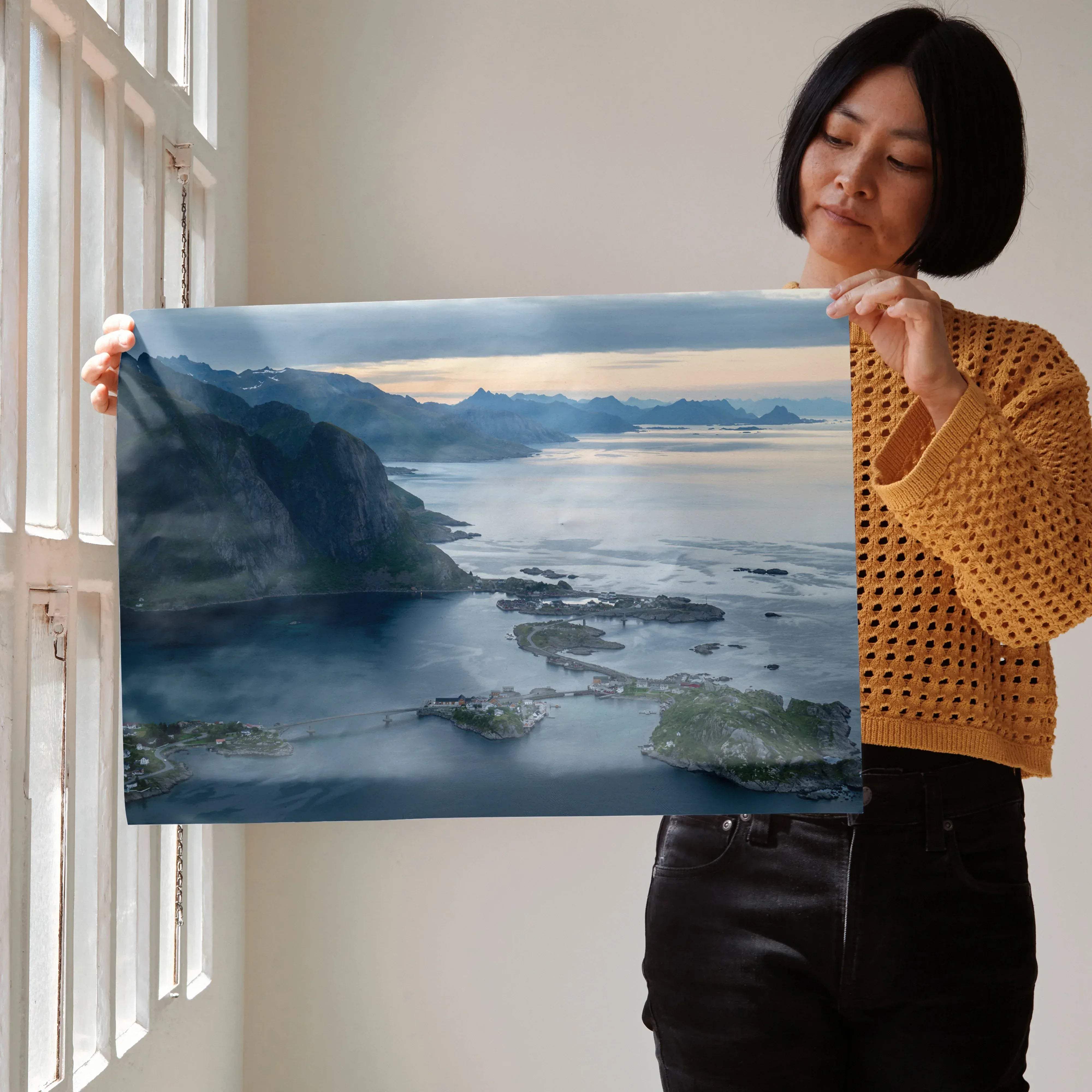 A rectangular framed print of stunning mountain sunset wall art featuring misty mountains and calm coastal waters