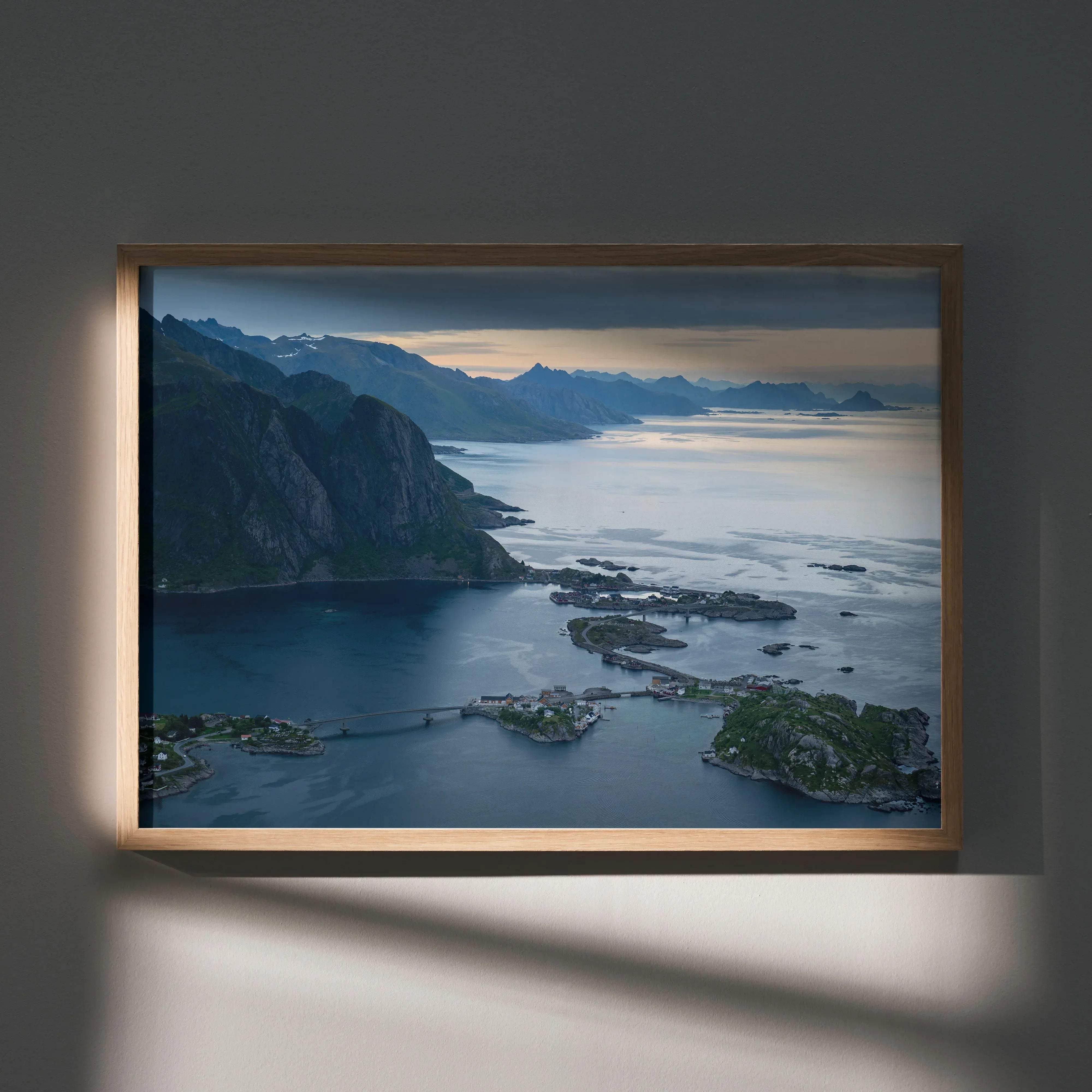 Stunning mountain sunset wall art poster featuring a serene fjord landscape in a light wood rectangular frame