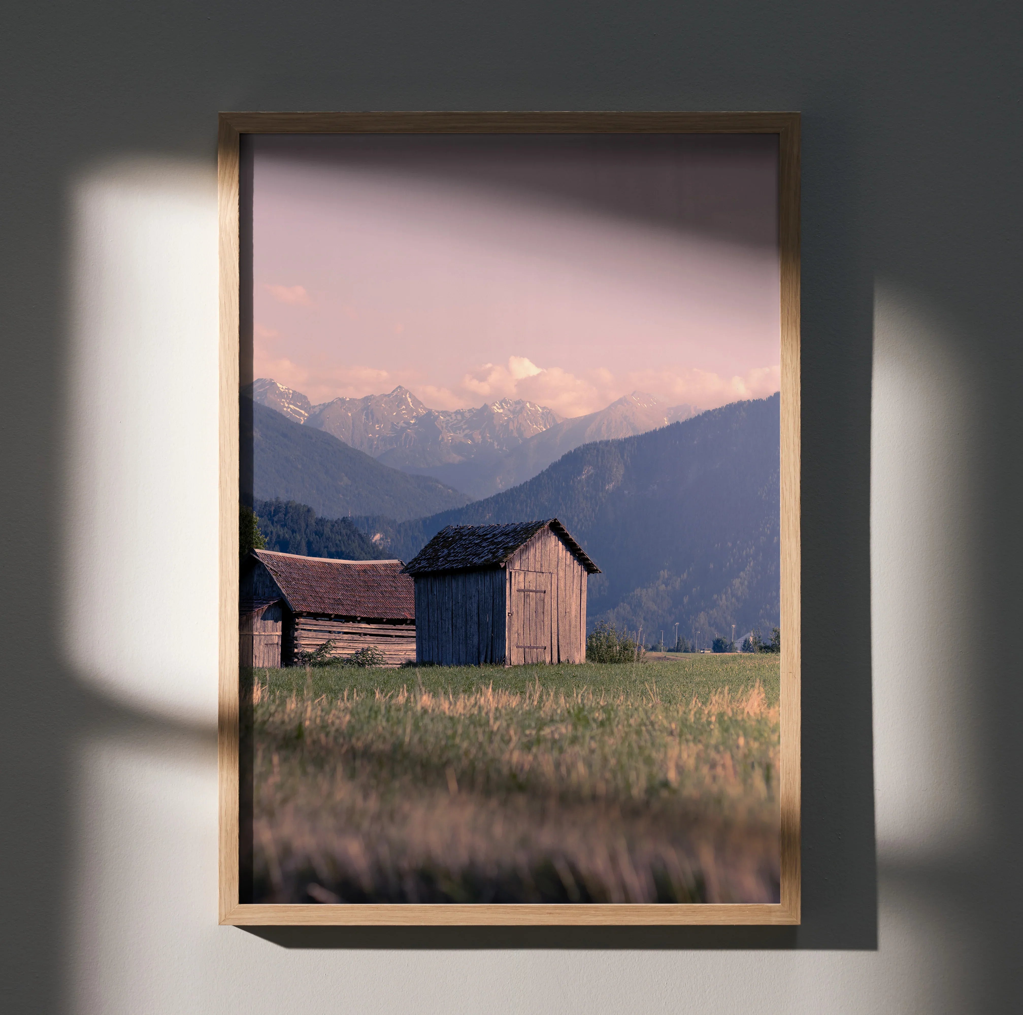 Majestic mountain landscape poster with wooden barns and soft sunset sky wall art.