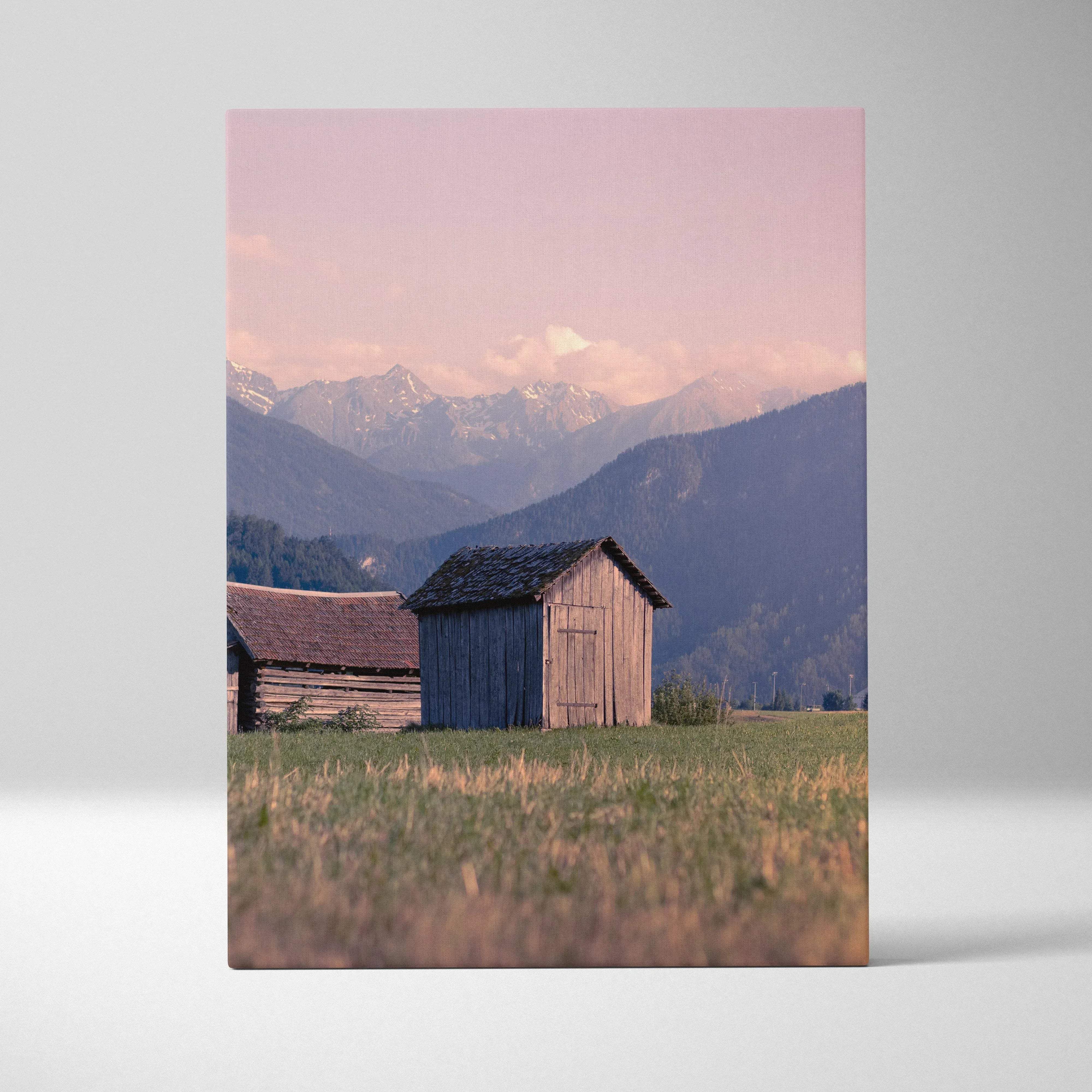 Rustic mountain village sunset canvas wall art showing a wooden shed with faded blue siding under a pink sky