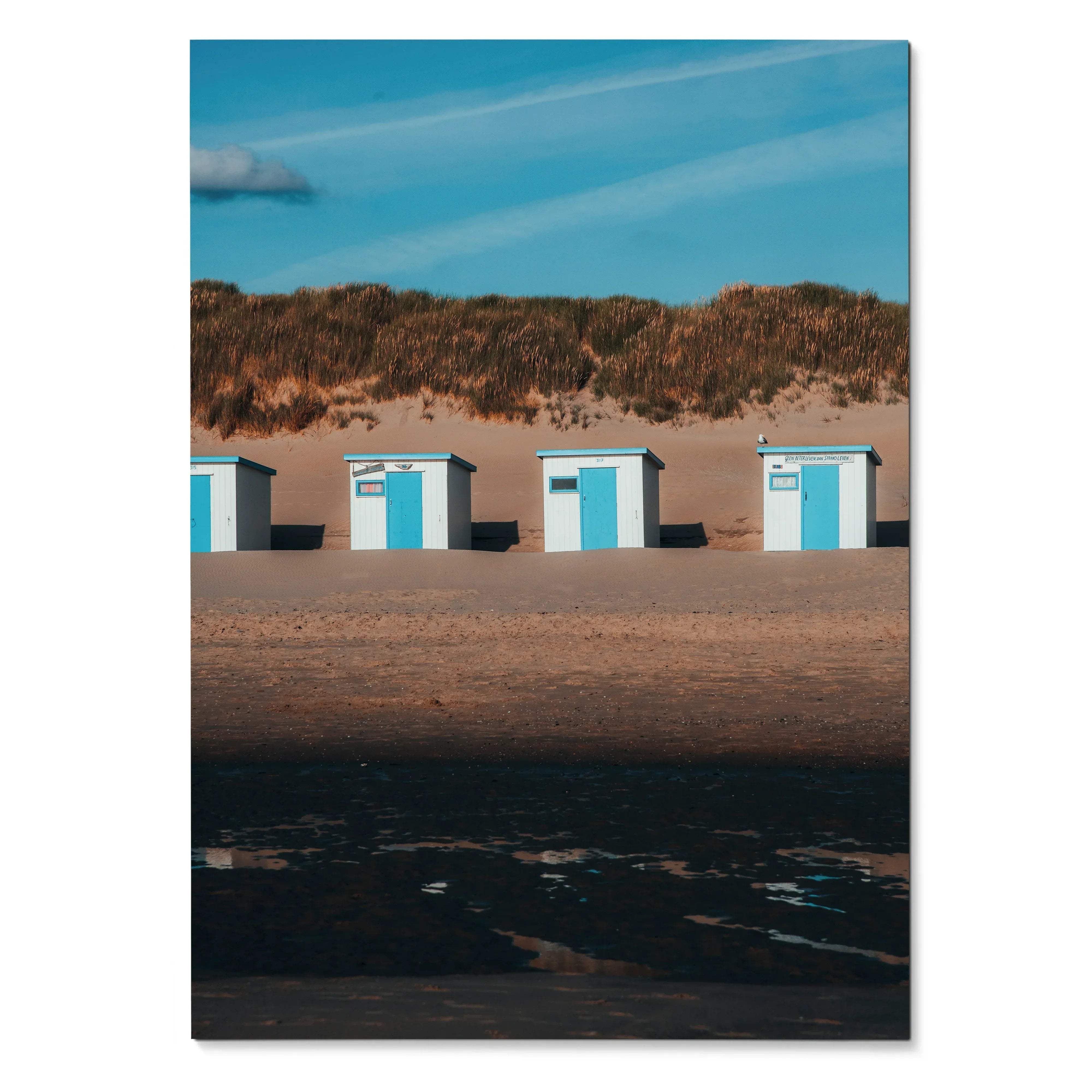 Serene beach landscape wall art poster showing four small blue and white beach huts under a blue sky.