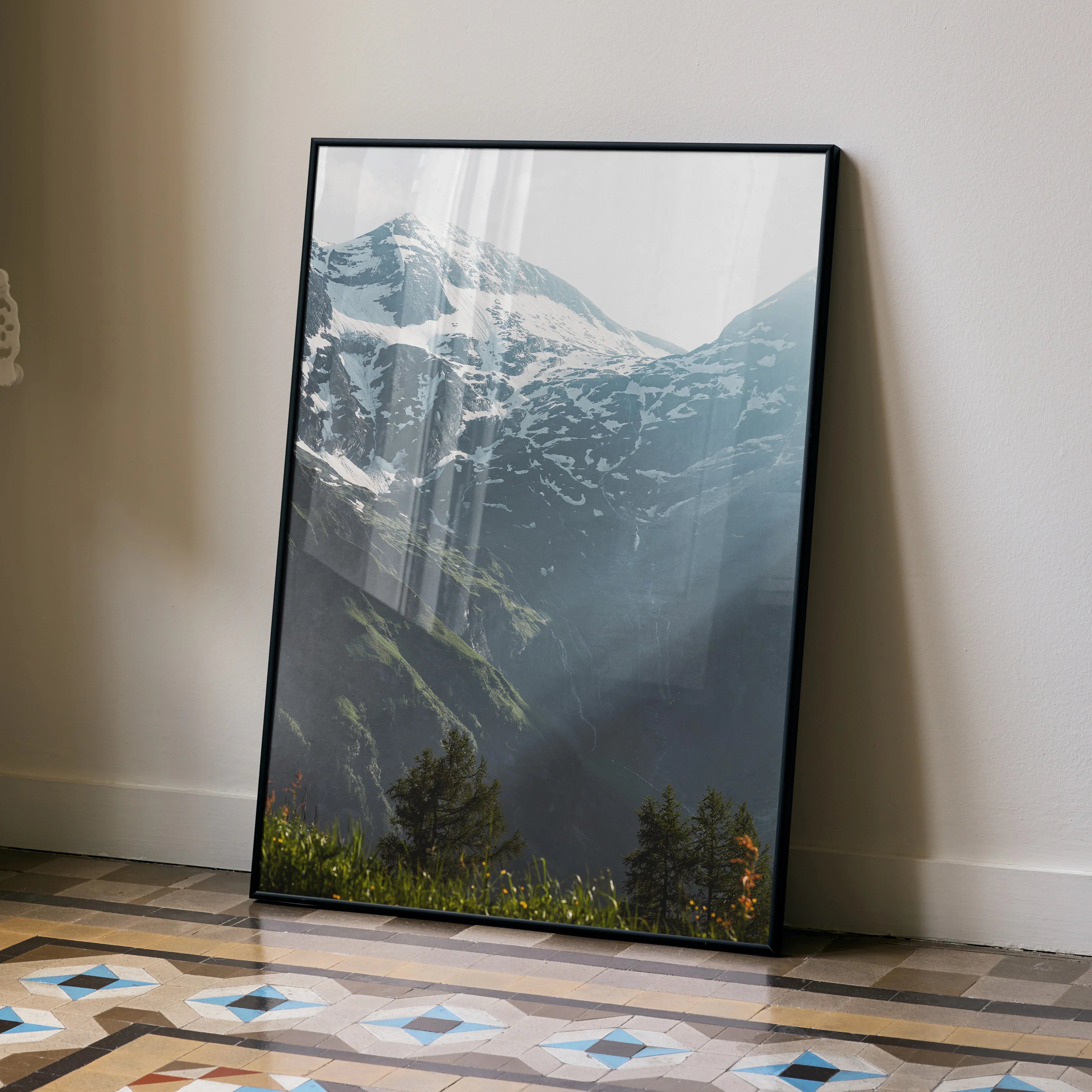 Vertical wall art poster of snow-capped mountains with sunlit valleys and lush greenery.