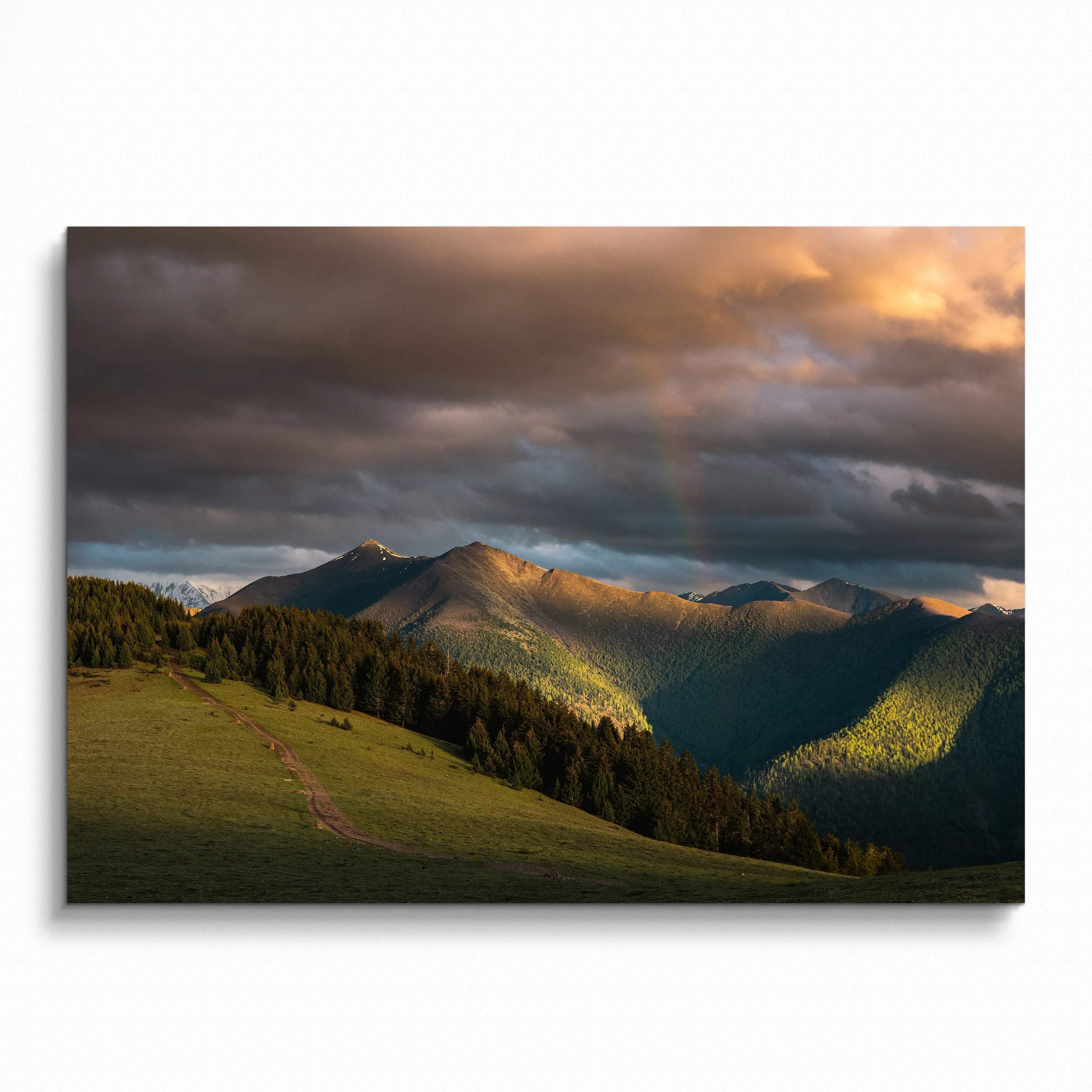 Majestic mountains under dramatic sunset sky with warm light and shadows wall art poster.
