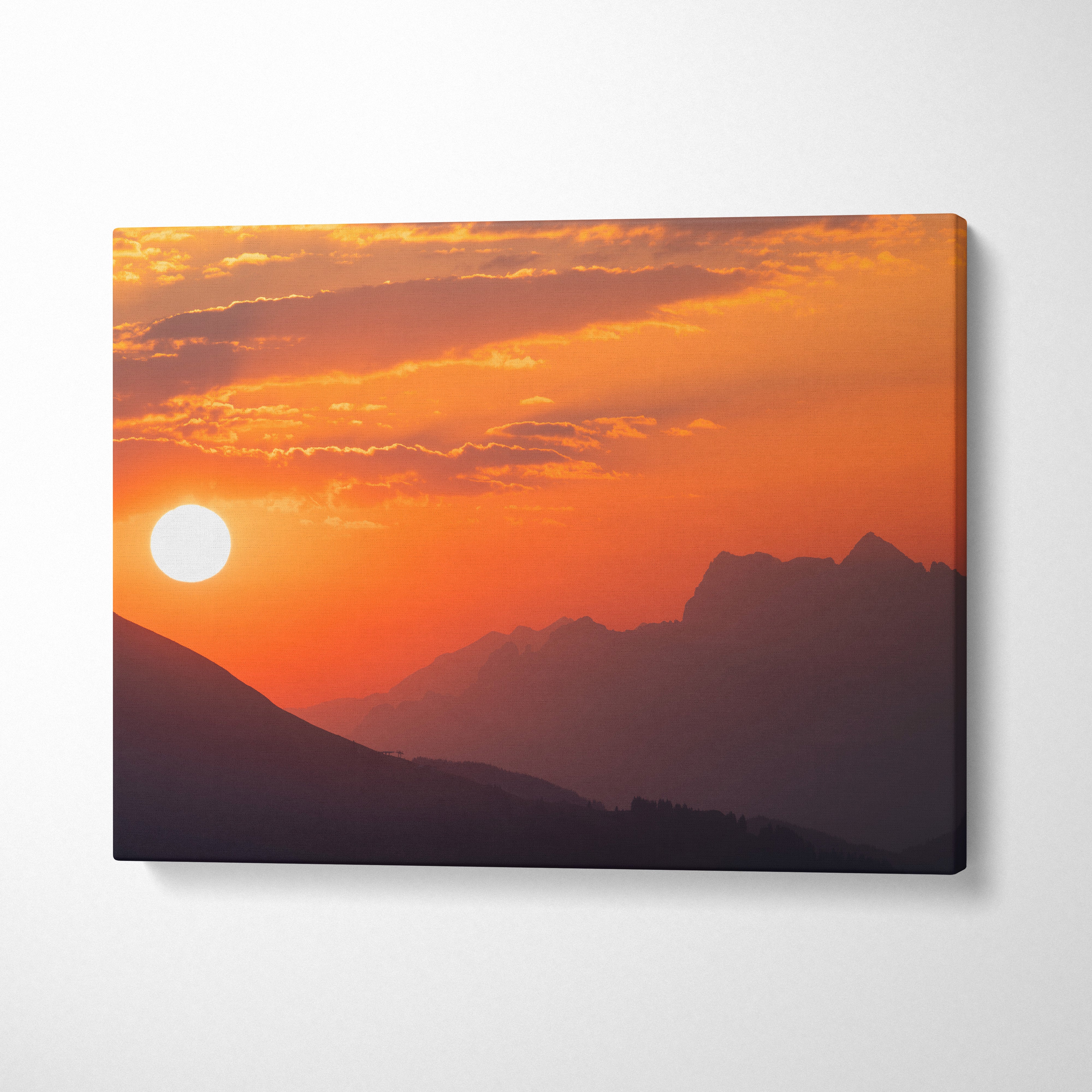 Canvas wall art featuring a vibrant orange sunset over shadowed mountain peaks.