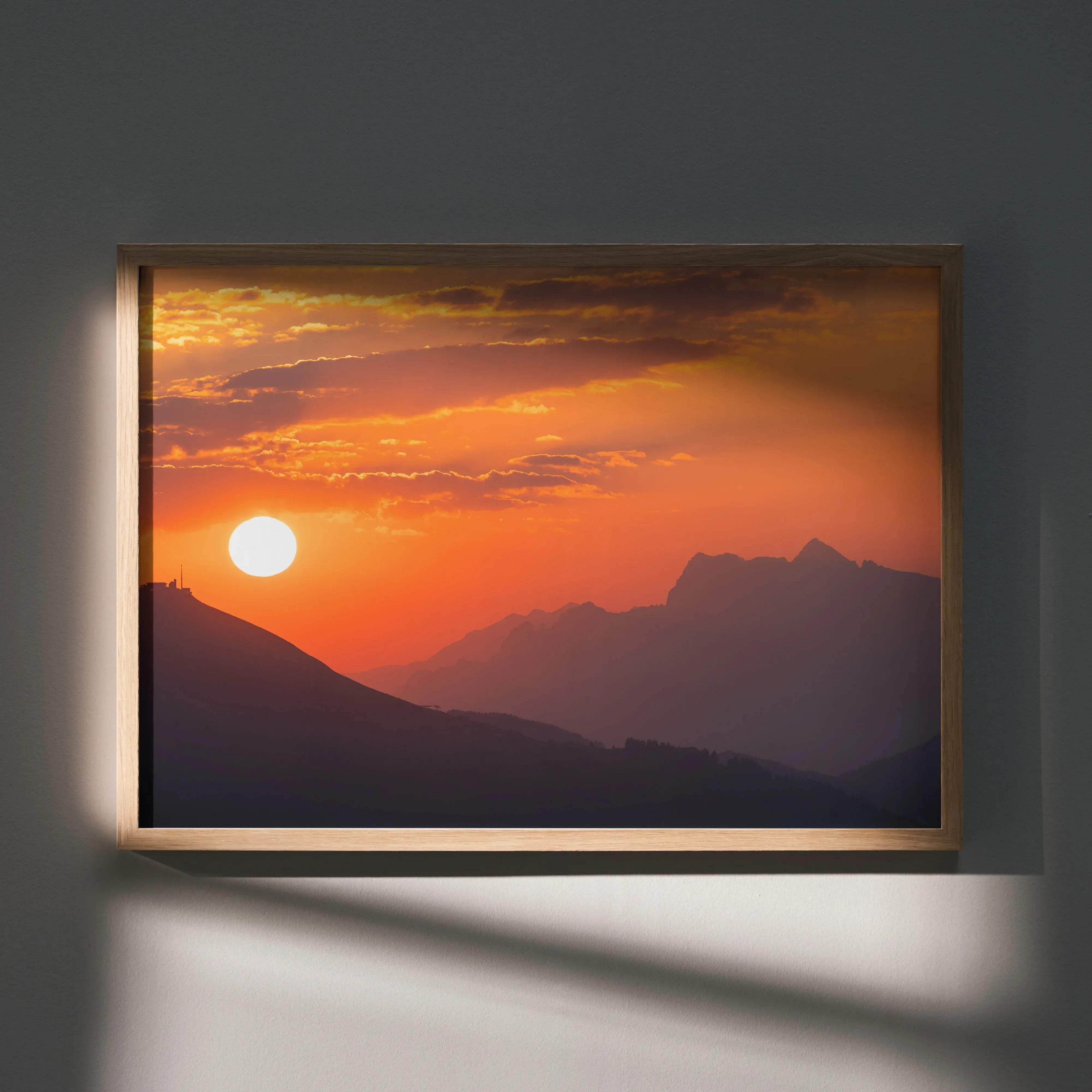 Majestic mountain sunset landscape art print with vibrant orange and yellow hues in a rectangular frame