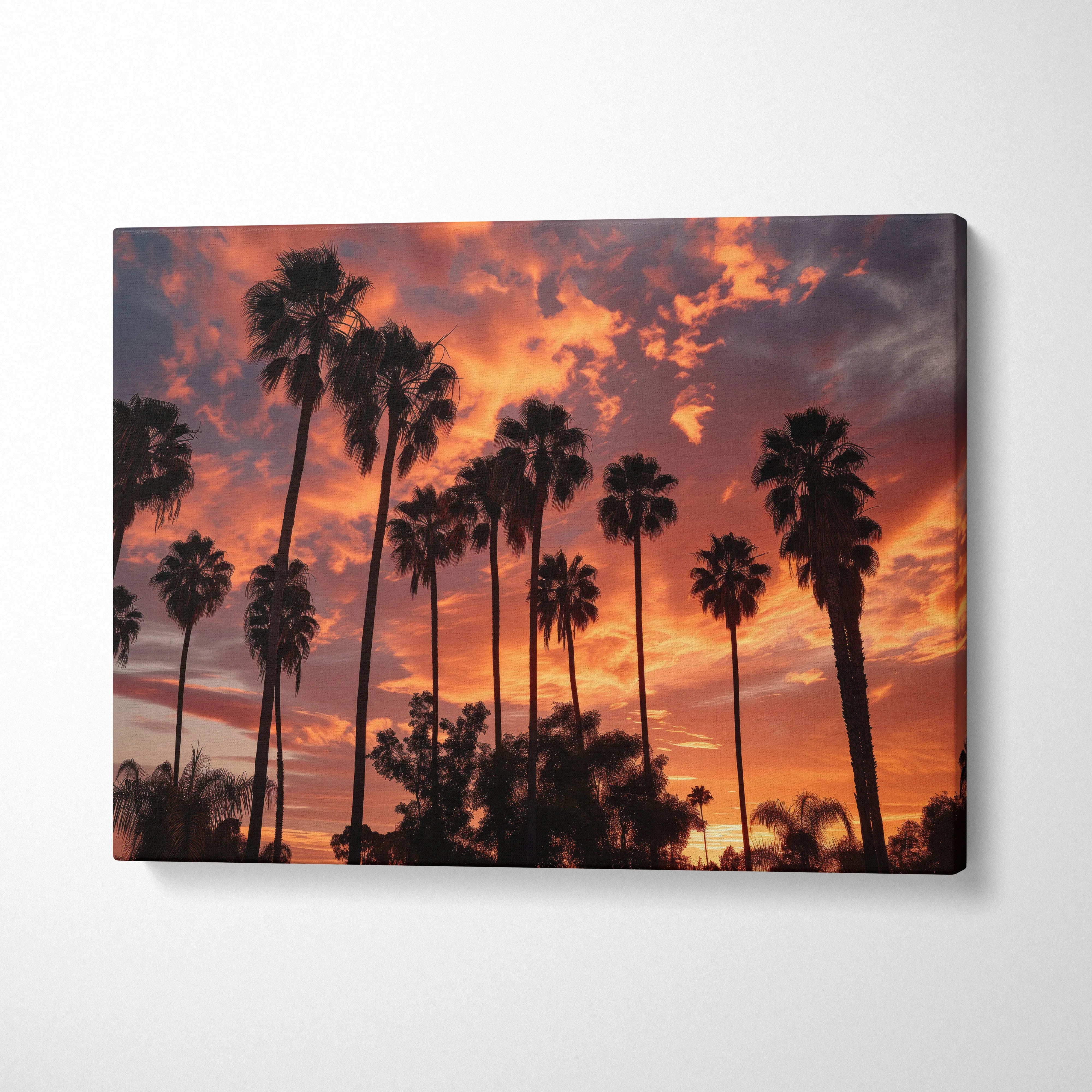 Tropical sunset palm tree silhouette on vibrant orange canvas wall art decor.