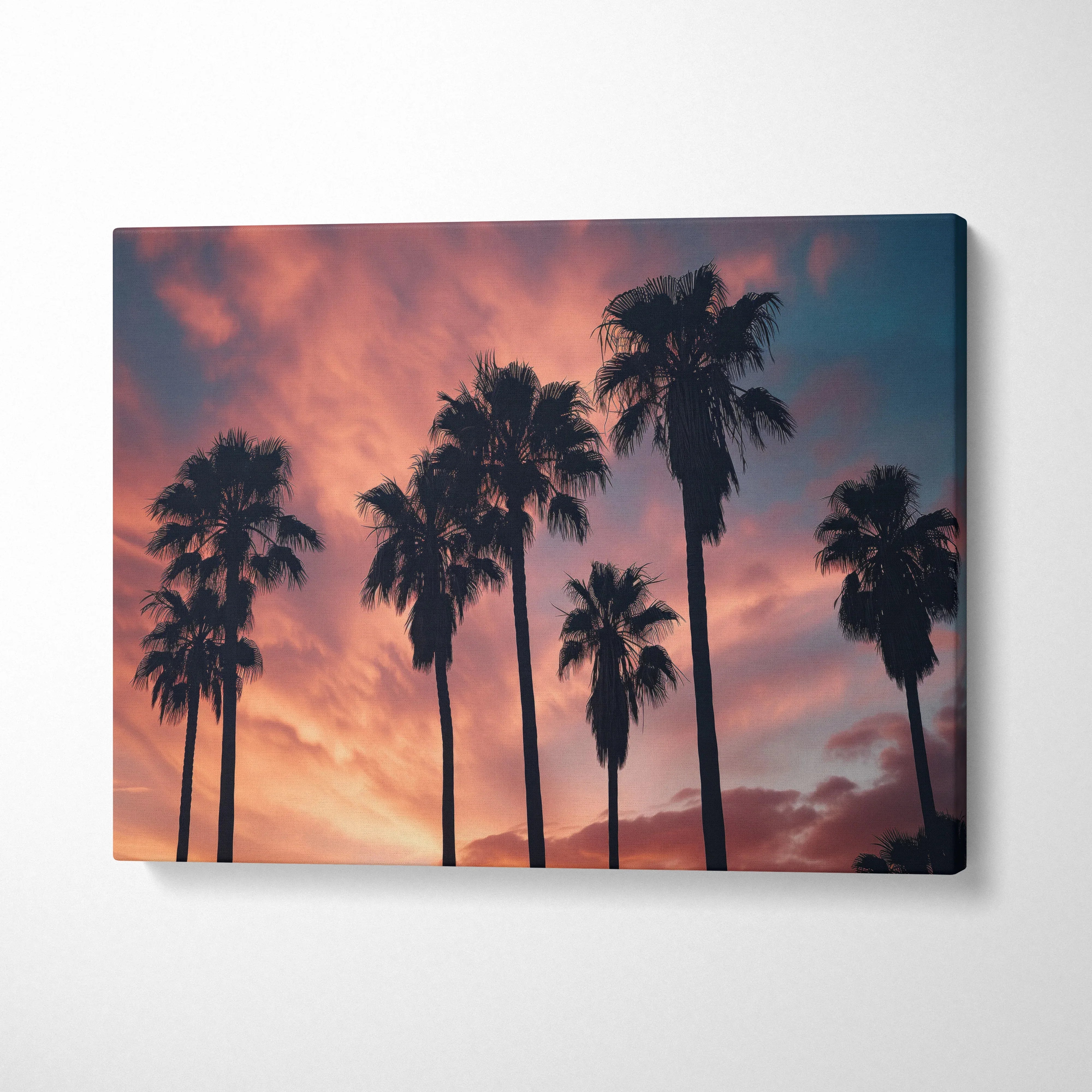 Canvas wall art featuring palm tree silhouettes against a vibrant tropical sunset sky decor.