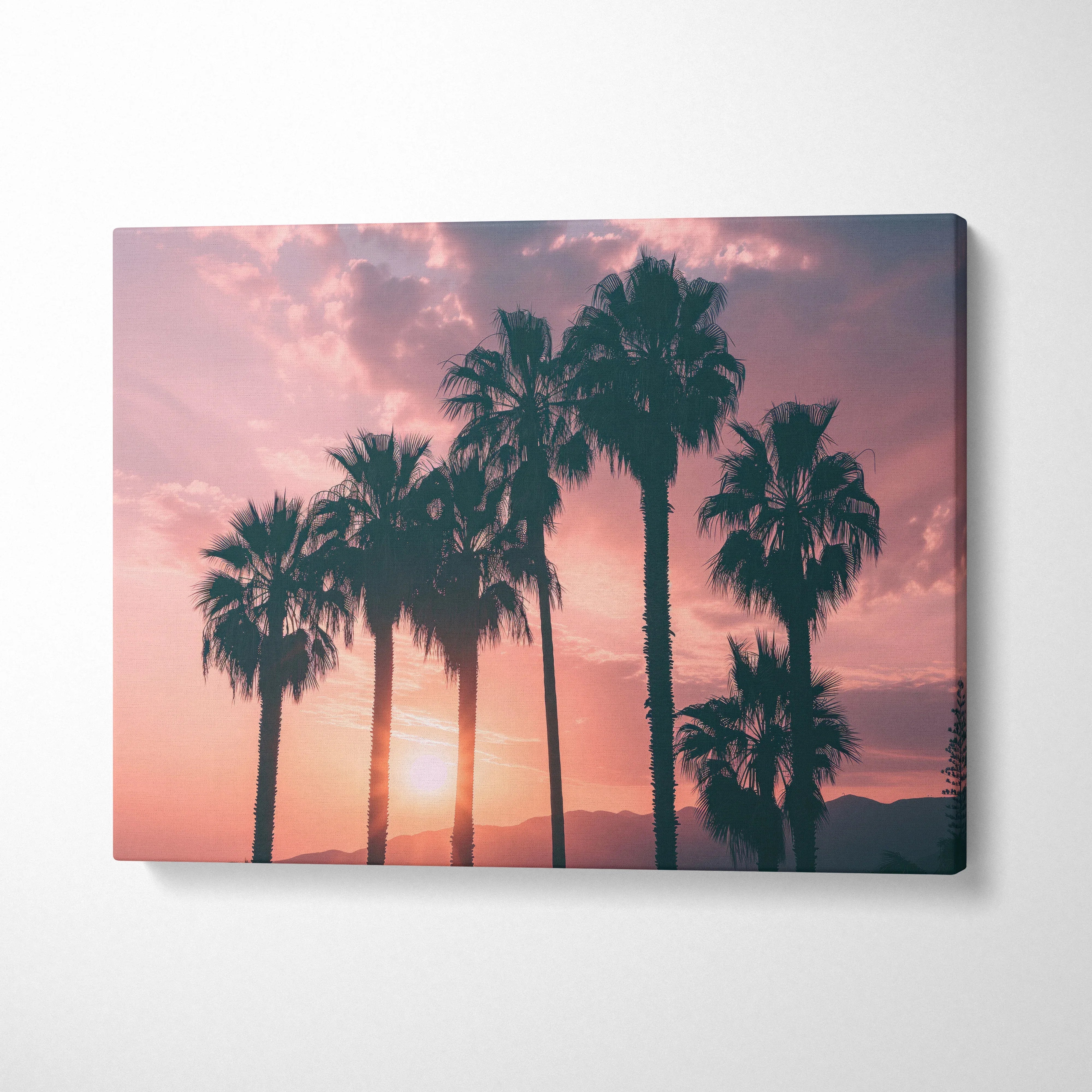 Palm tree silhouette at sunset with warm pink and orange tones on canvas wall art decor.