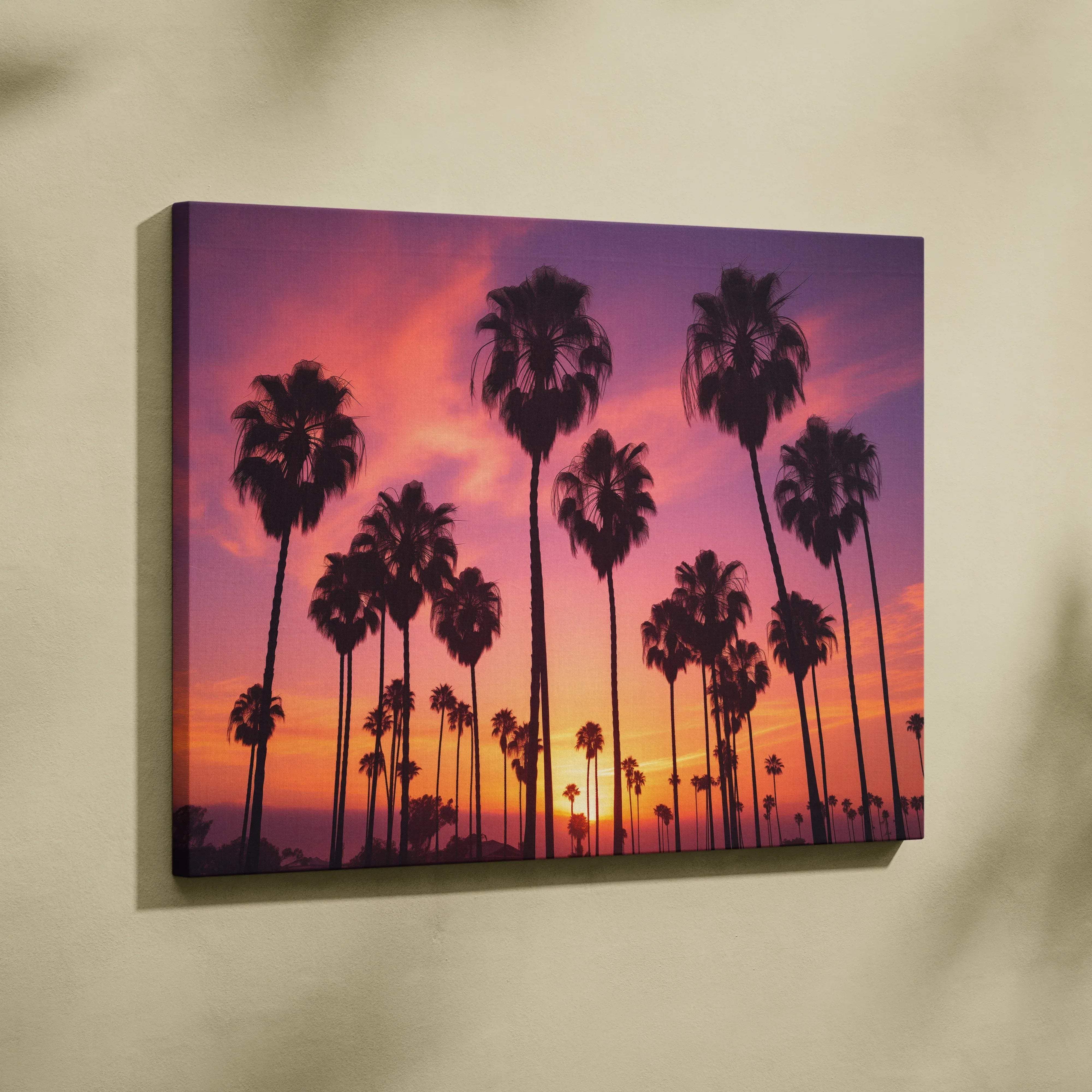 A vibrant canvas wall art of silhouetted palm trees against a pink and purple tropical sunset sky