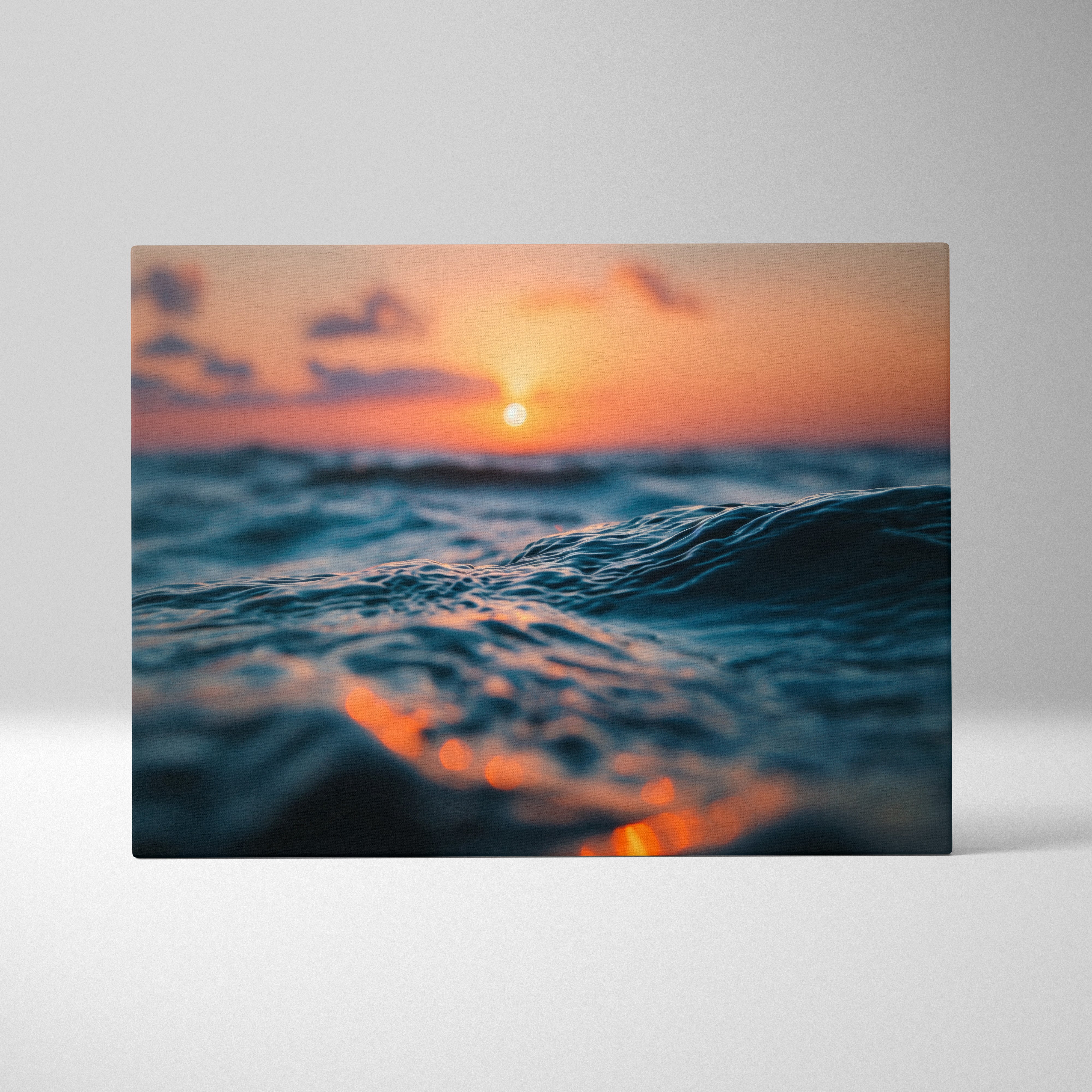 Golden sunset over ocean waves on horizontal canvas wall art in warm tones.