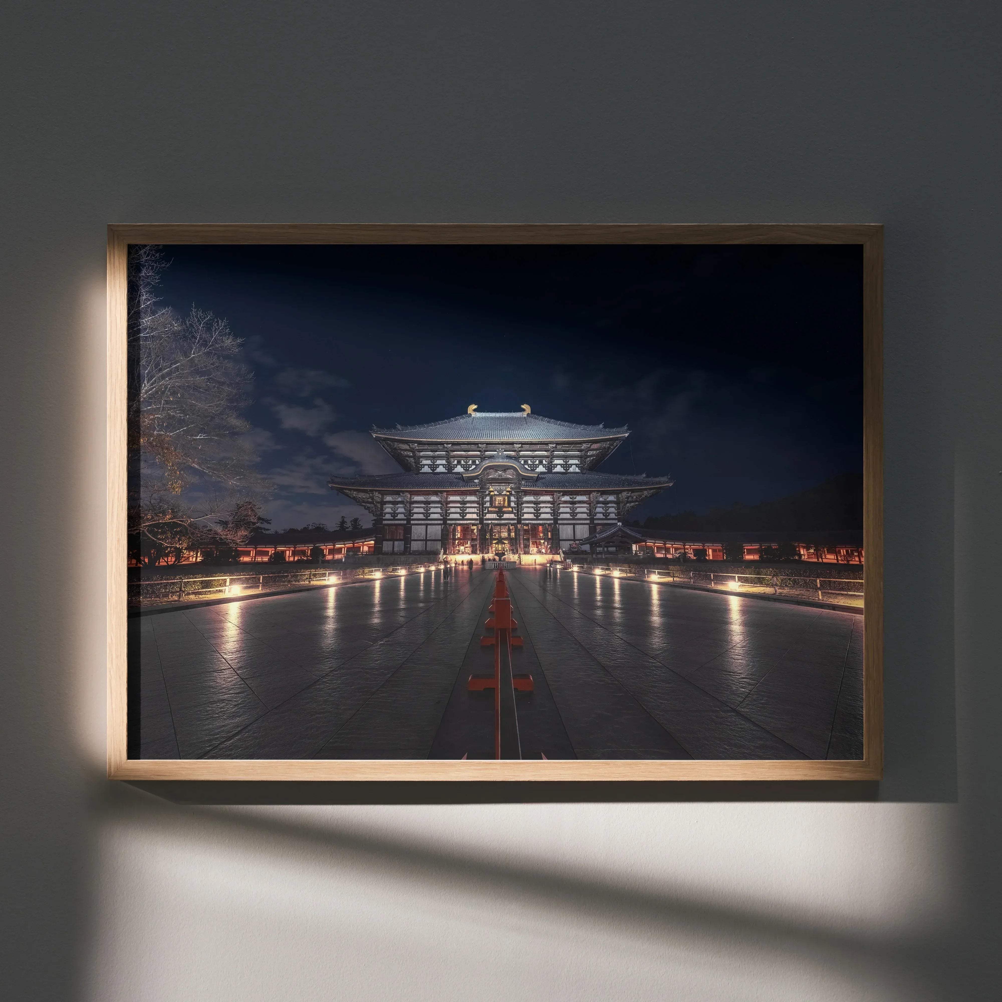 A framed art print poster of a grand illuminated japanese temple at night with reflective pathways and traditional architecture