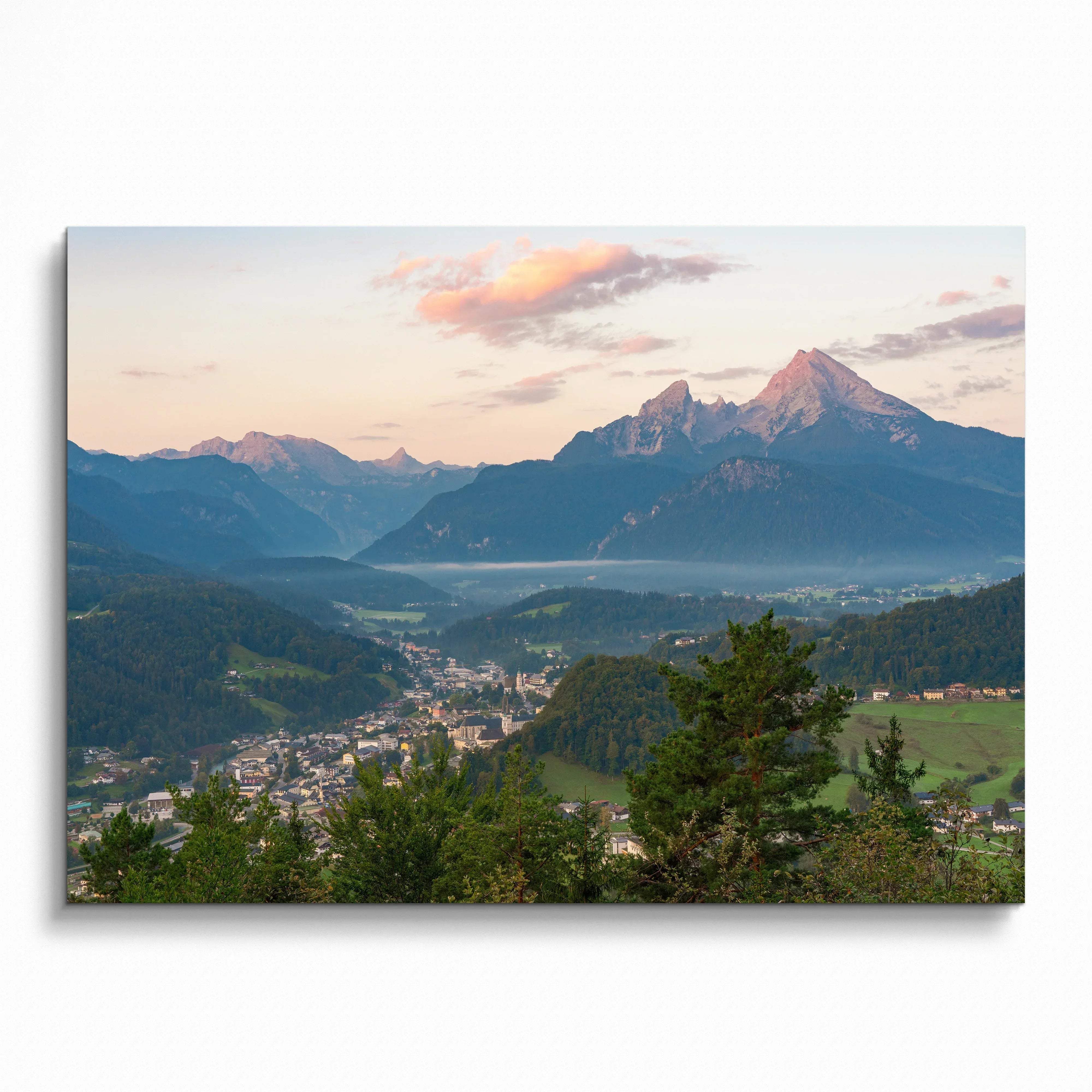 Mountain sunset wall art poster with vibrant pink and orange sky over a scenic valley and forested peaks.