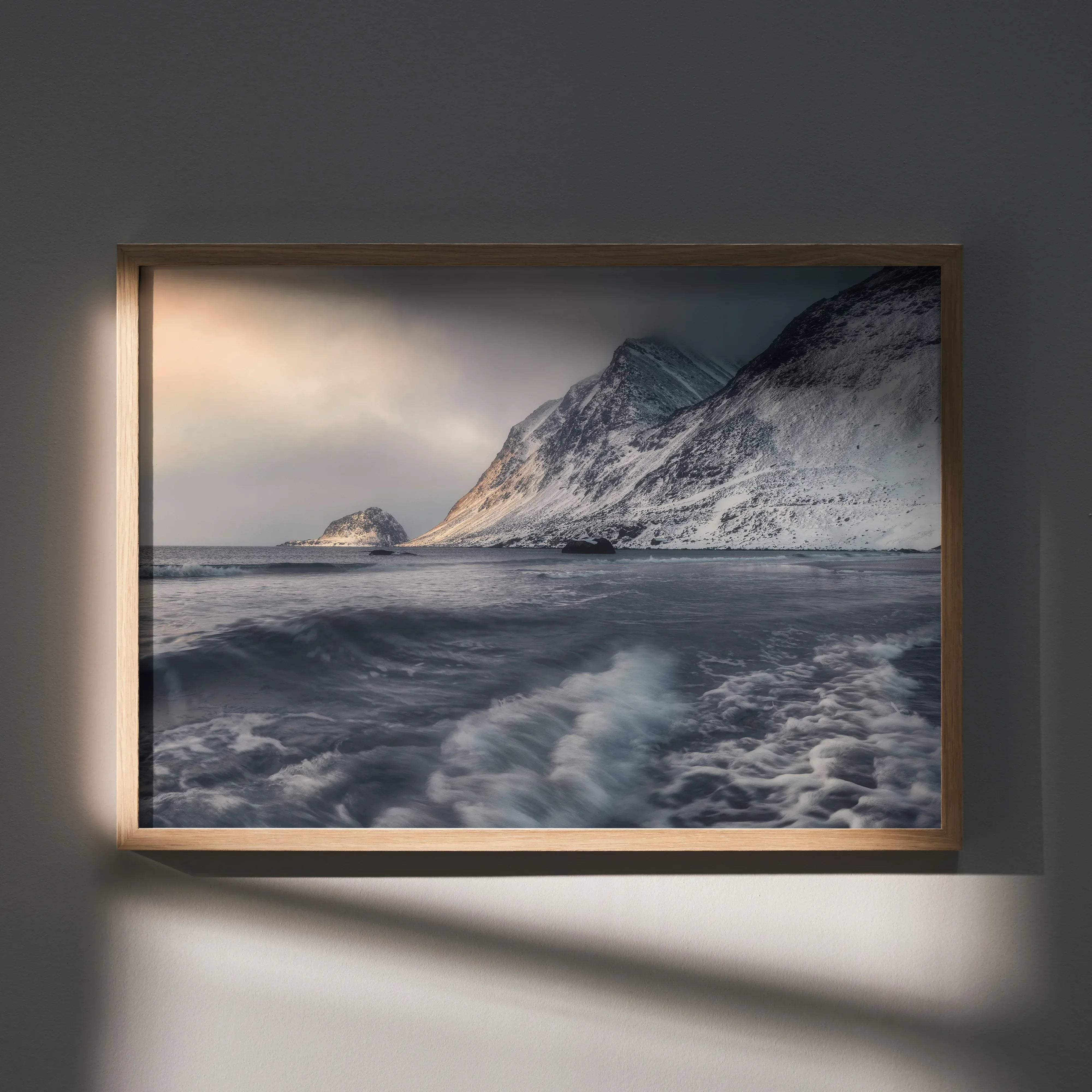 Majestic mountain sunset snowy peaks art poster with minimalist wooden frame featuring snowy mountain and crashing waves in muted grays and whites