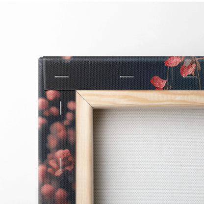 Framed black canvas print with red floral surreal pink blossoms on dark ground
