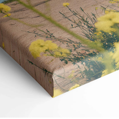 Canvas print of surreal windmill over yellow wildflowers field on rustic wood