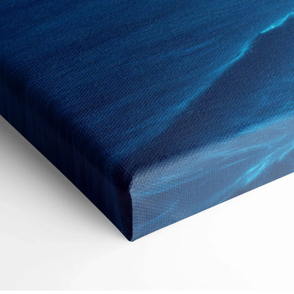 Deep blue textured canvas print of moody blue coastal cliff with solitary figure