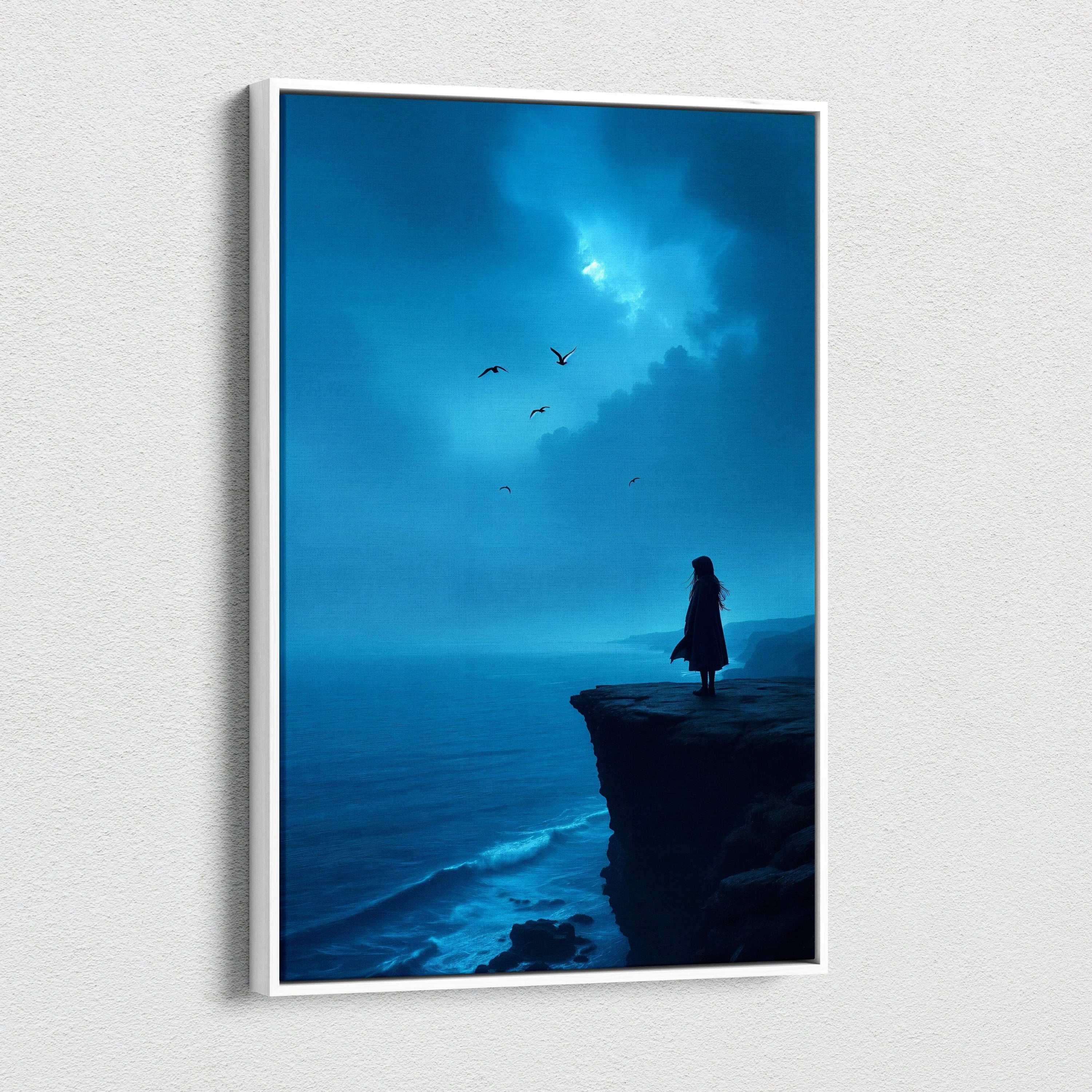 Blue-toned canvas wall art of solitary figure on coastal cliff overlooking moody ocean