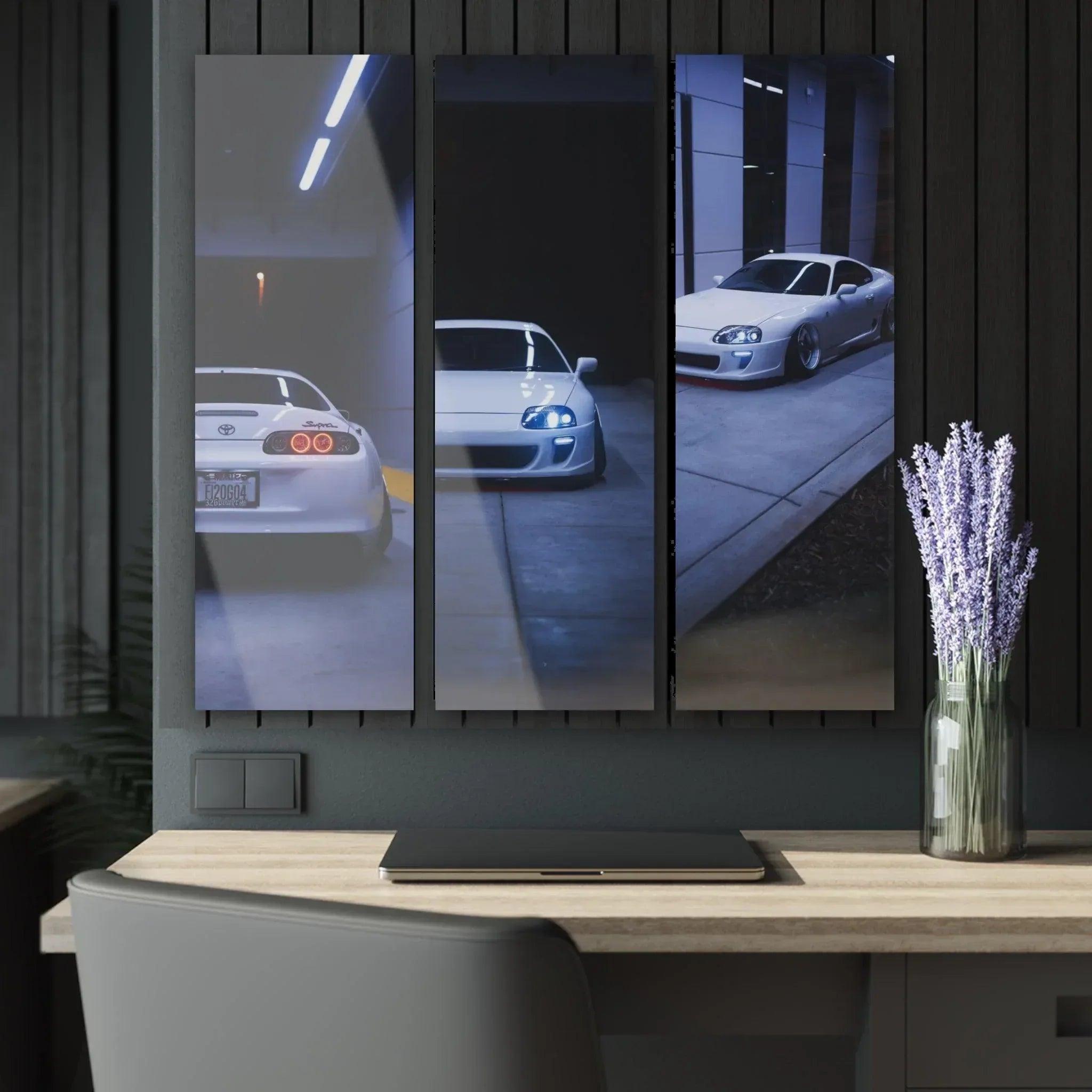 Toyota Supra MK4 reflected in glass panels on glossy canvas wall art triptych above desk.