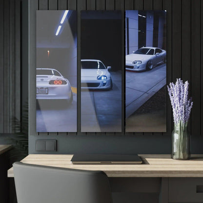 Toyota Supra MK4 reflected in glass panels on glossy canvas wall art triptych above desk.