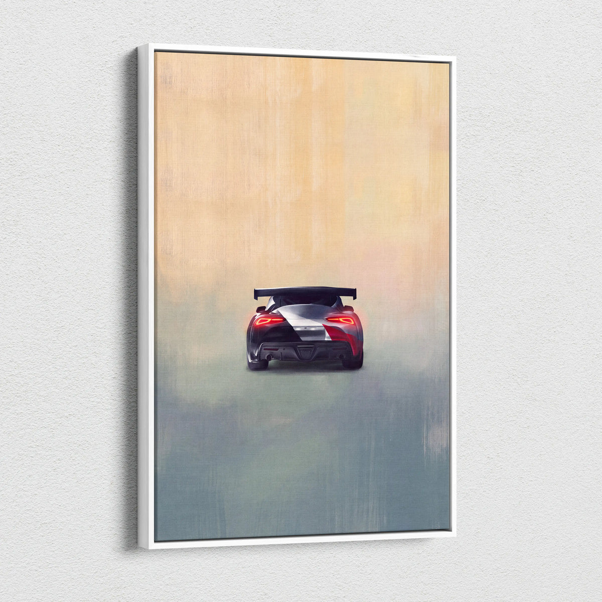 A framed Toyota GR Supra inspired canvas art showing the rear view of a red and black sports car with white stripe