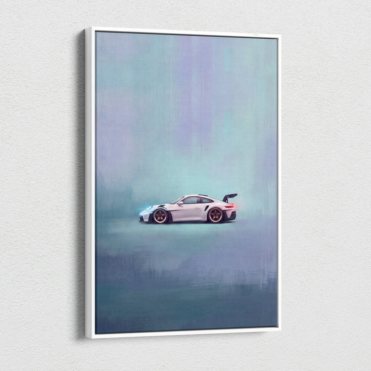 A framed canvas print of a white Porsche 911 GT3 RS with gold rims against a misty teal and purple background