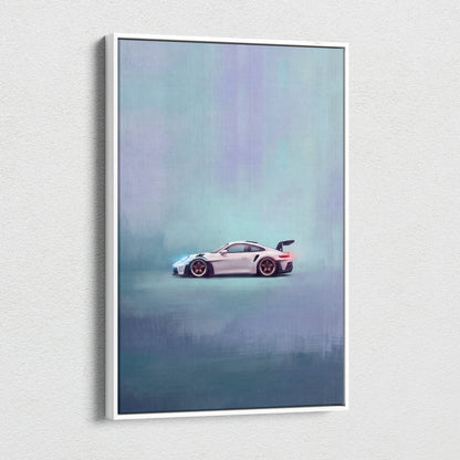 A framed canvas print of a white Porsche 911 GT3 RS with gold rims against a misty teal and purple background