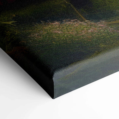 Black canvas print of whimsical storybook cottage with mossy roof in glowing forest garden