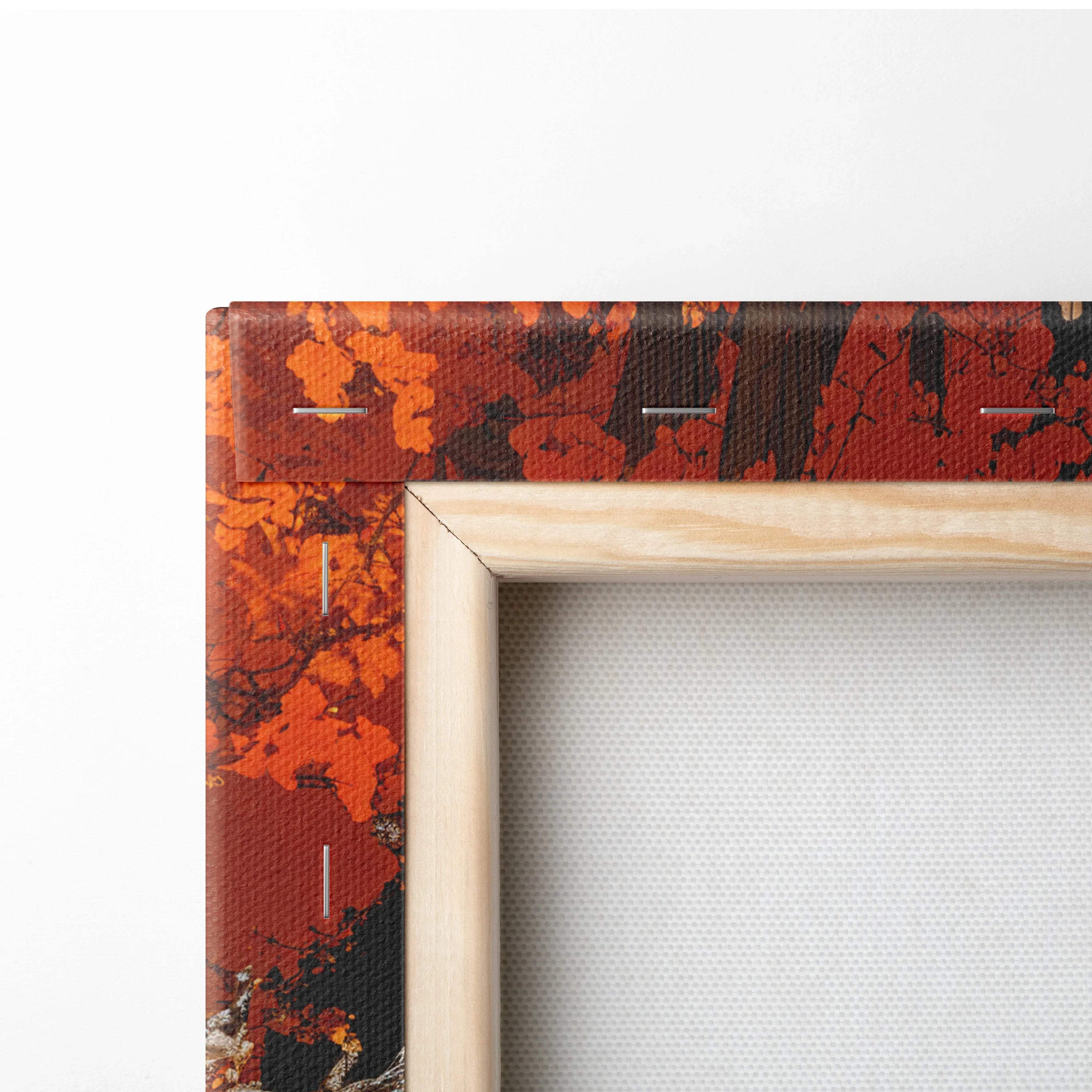 Dreamlike Autumn Lane canvas print with orange black leaf pattern in light wood frame