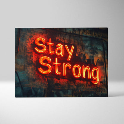 Vibrant orange neon Stay Strong sign on weathered canvas backdrop