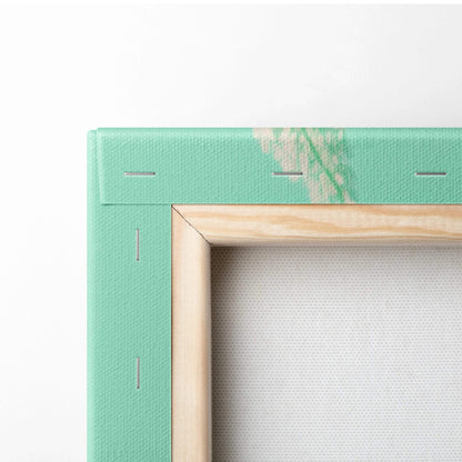 Back of mint green canvas with wooden frame, visible edge stitching