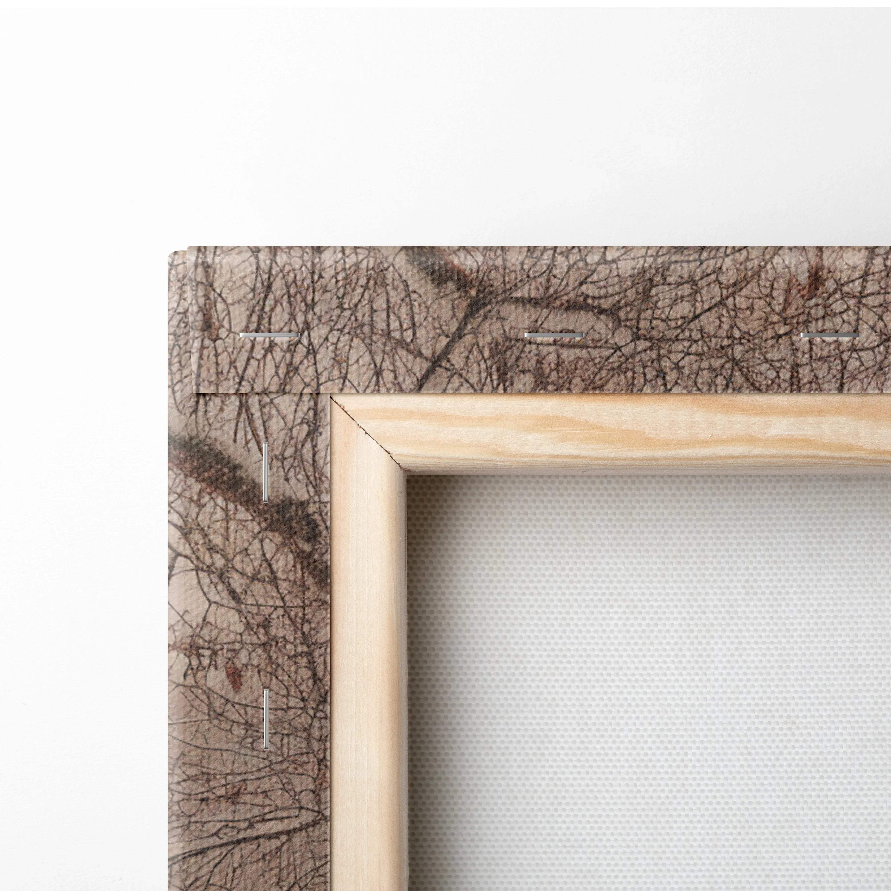 Back of cozy snowy log cabin canvas wall art with beige tree branch frame