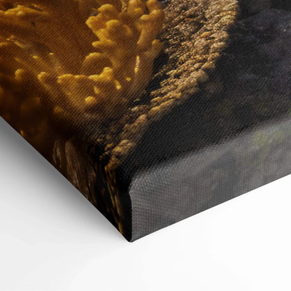Textured golden-brown coral reef canvas print with fish in azure blue water