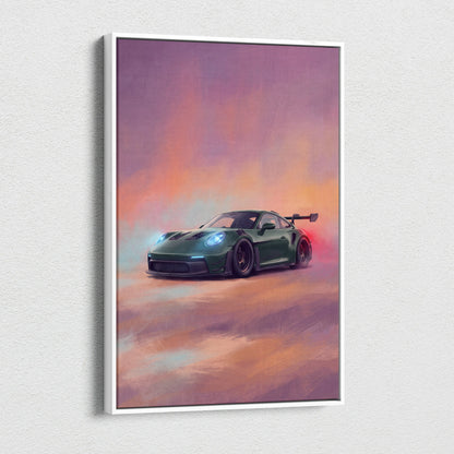 A framed canvas print of a dark green porsche 911 gt3 rs with glowing headlights set against a sunset sky